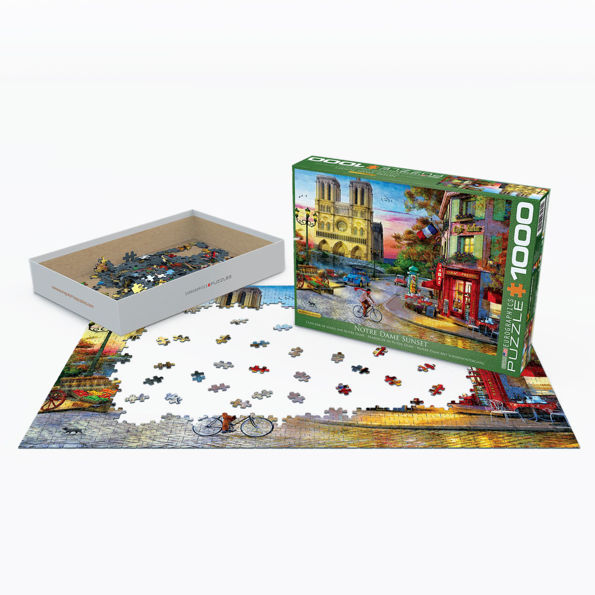 Puzzledose und fertiges Puzzle von Notre Dame bei Sonnenuntergang.