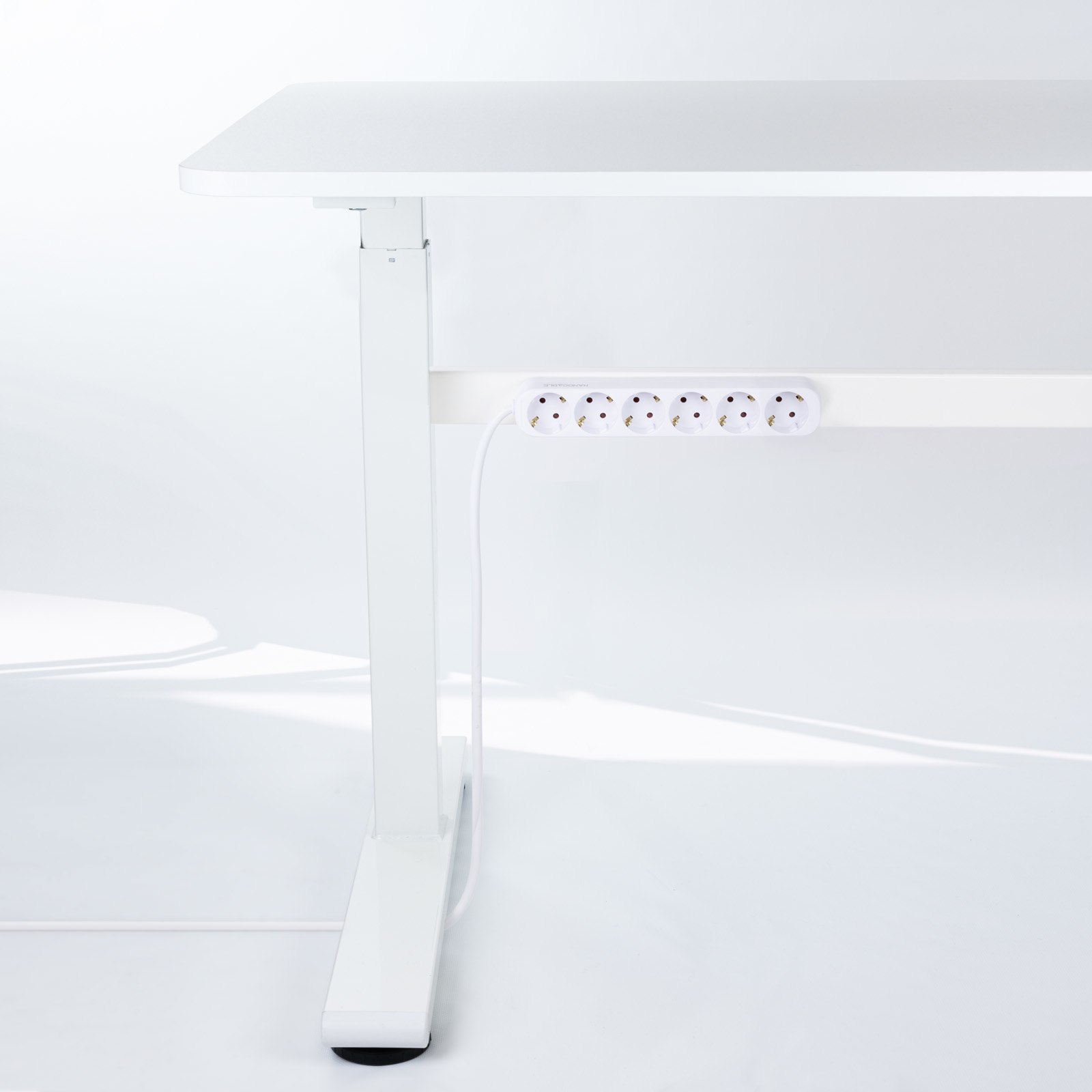 Witte bureau met een stekkerdoos eronder bevestigd. De achtergrond is wit.