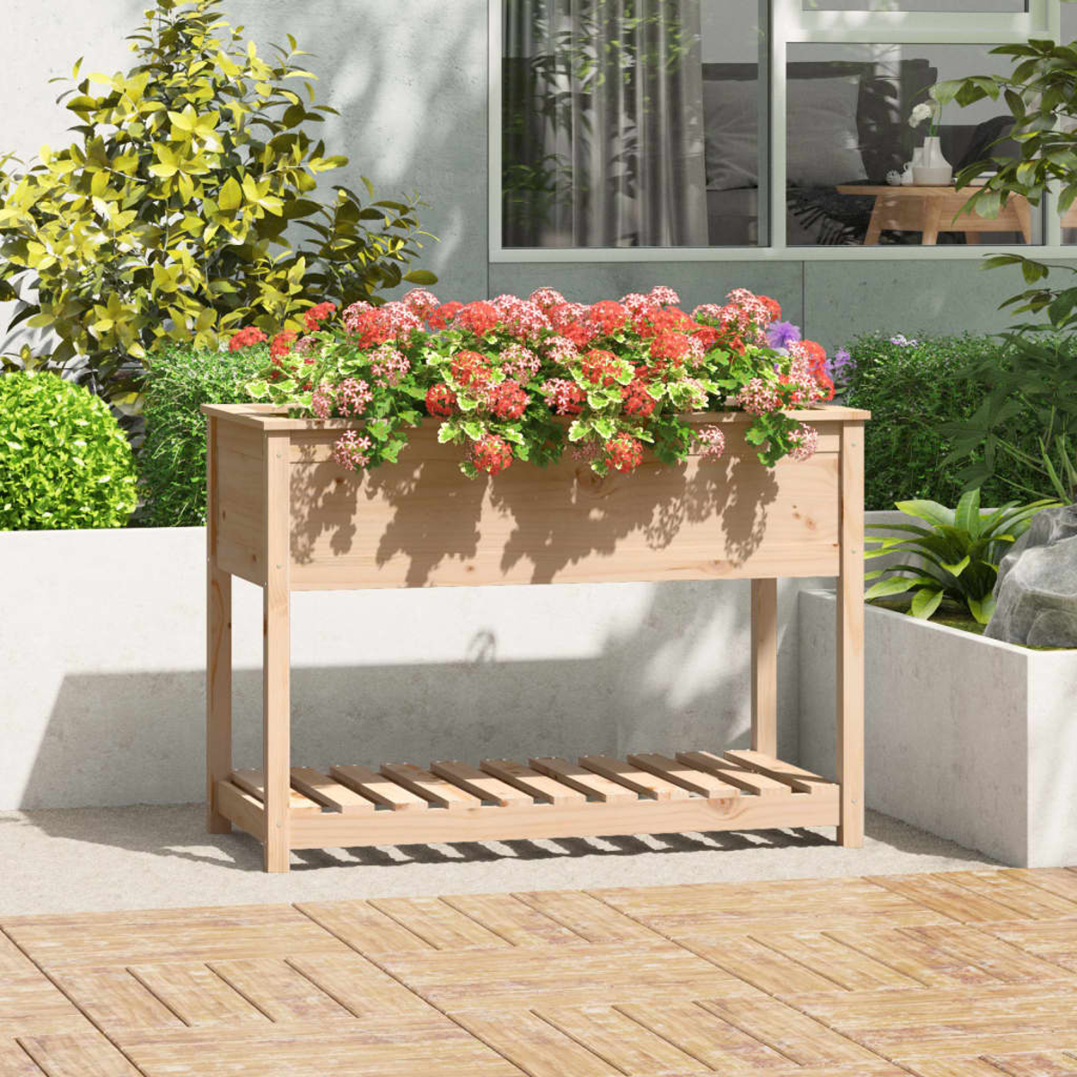 Holz-Pflanzkasten mit roten und grünen Blumen. Auf Terrasse mit Grünpflanzen.