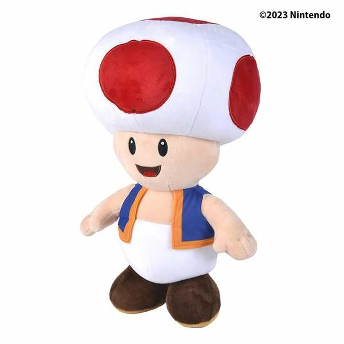 Toad-Plüschtier mit weißem Kopf, roten Punkten und blauer Weste, lächelnd.