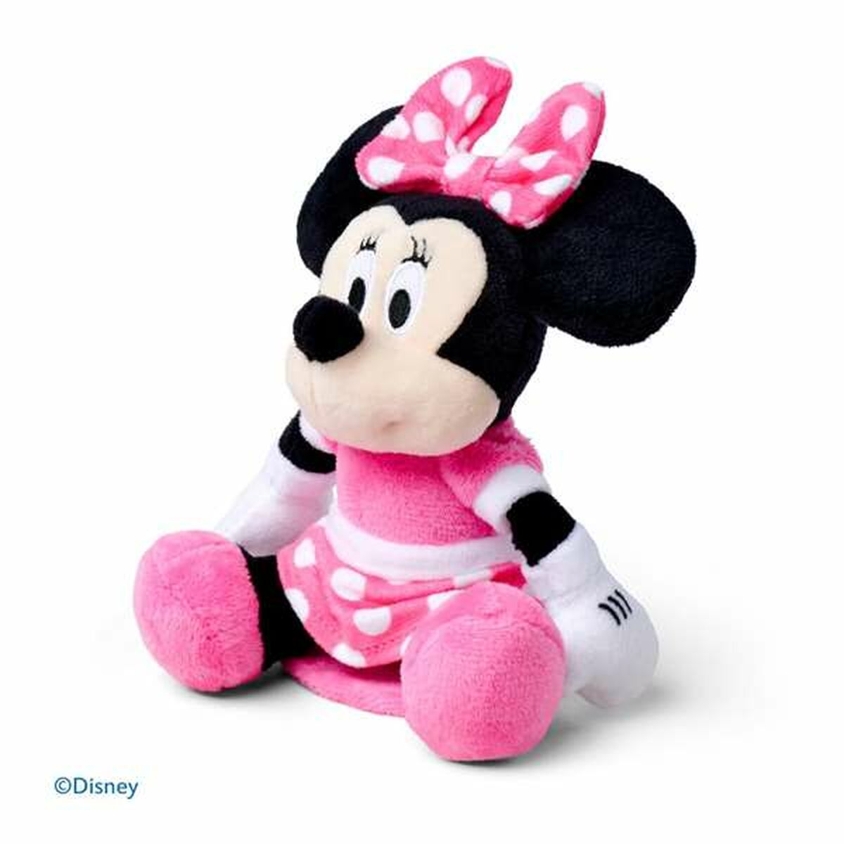 Minnie Mouse Plüschtier, rosa Kleid mit weißen Punkten, auf weißer Oberfläche sitzend.
