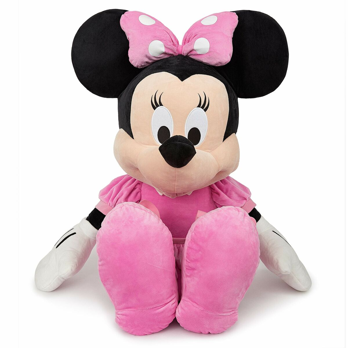 Minnie Mouse Plüschpuppe, die ein rosa Kleid mit weißen Punkten trägt, sitzend.