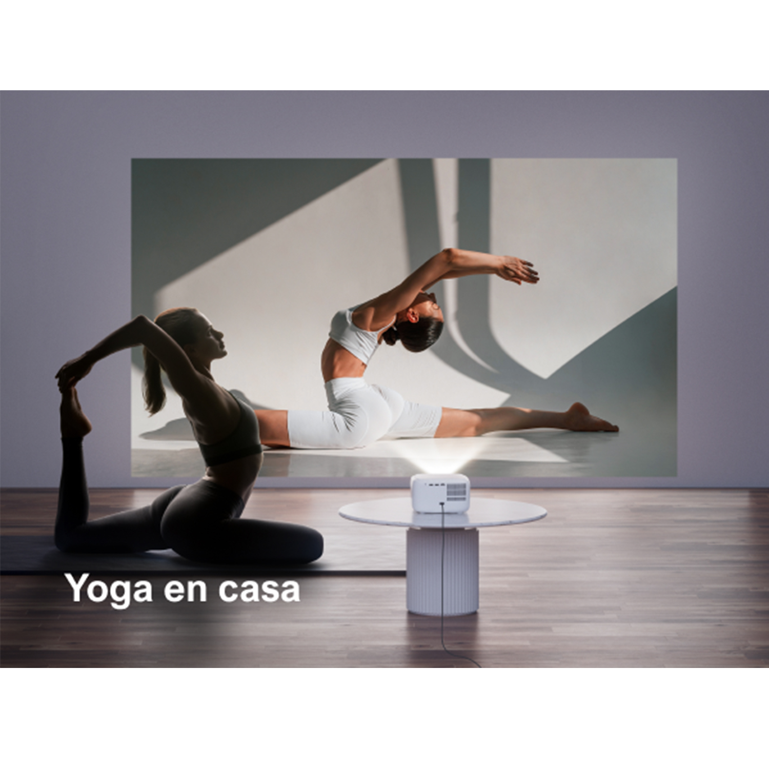 Una mujer practicando yoga en una esterilla. Un proyector muestra la misma escena.