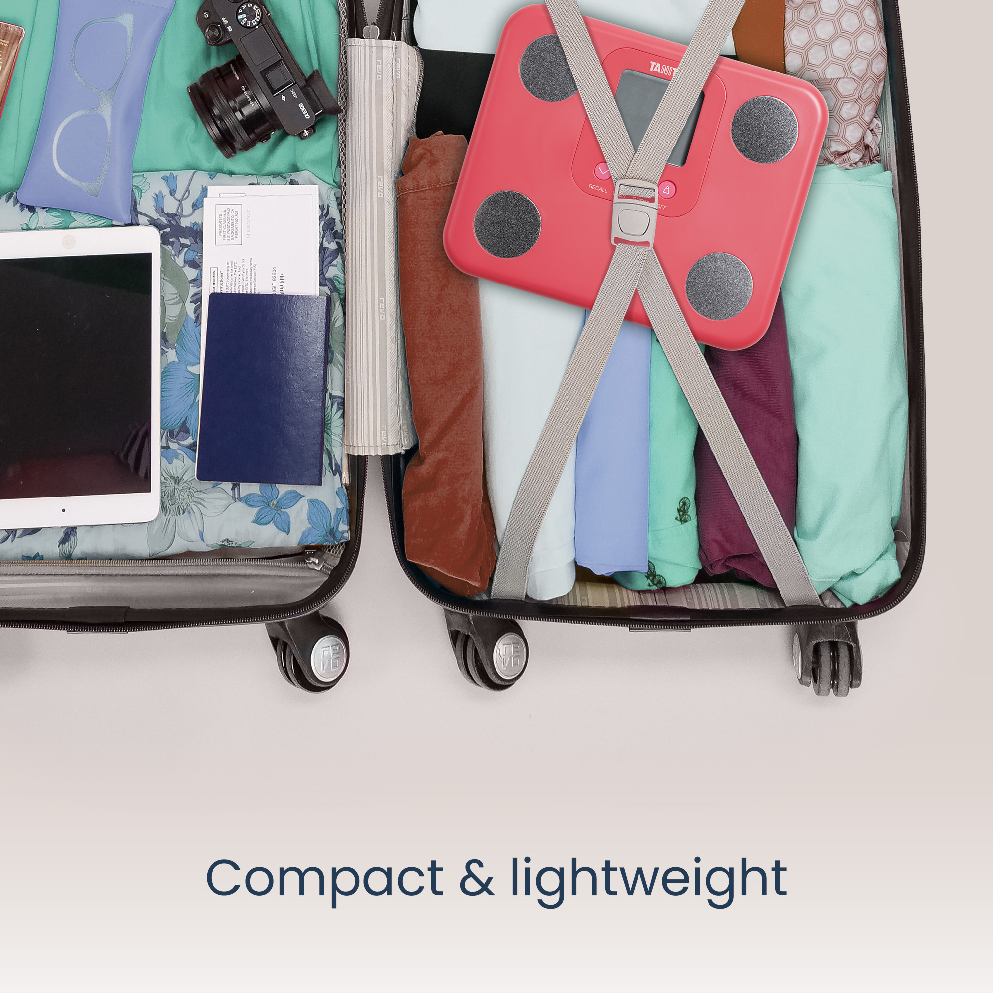 Open koffer met kleding, weegschaal en reisaccessoires. Compact en lichtgewicht.