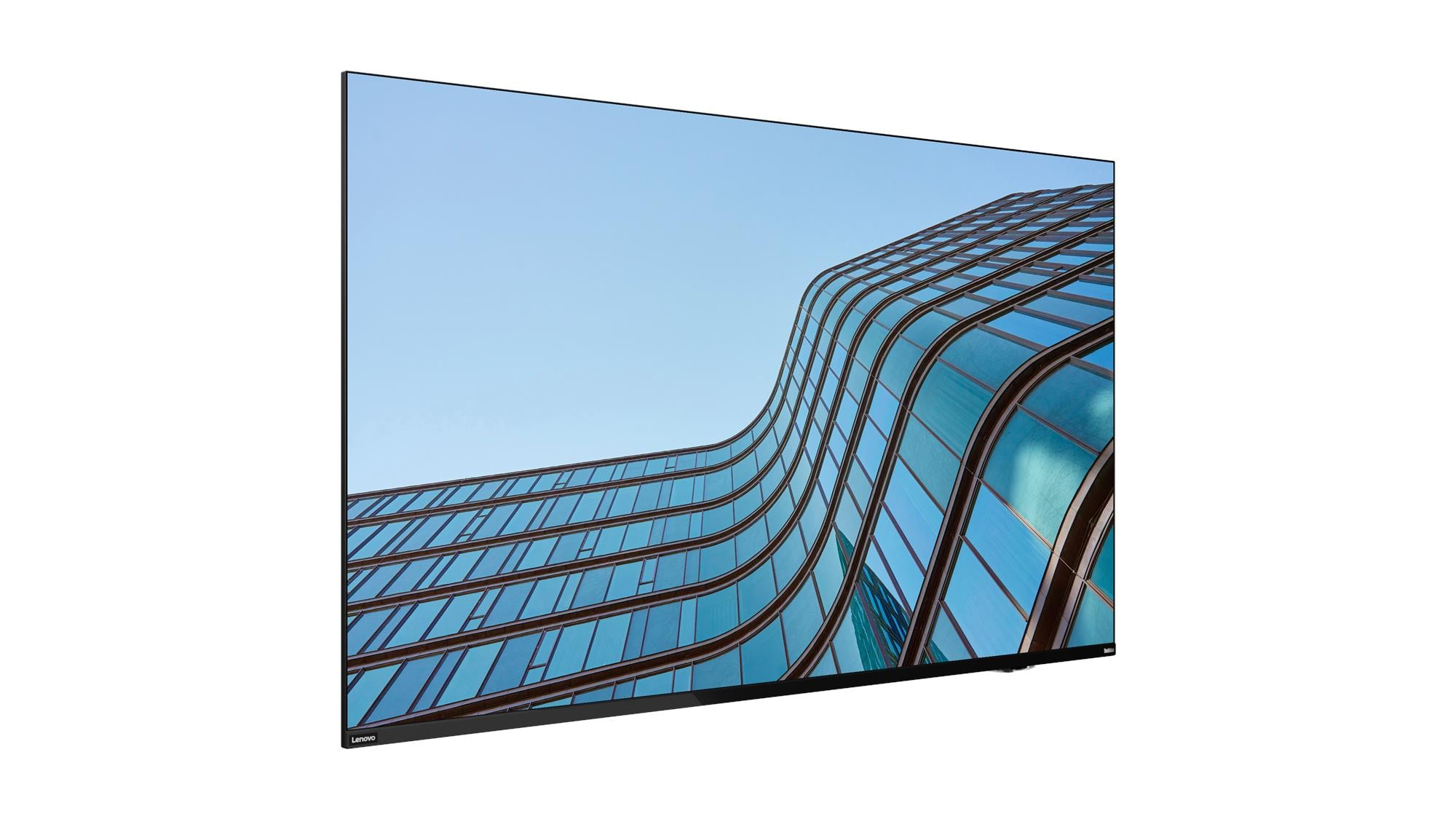 Czarny monitor Lenovo wyświetla szklaną fasadę budynku na tle błękitnego nieba.