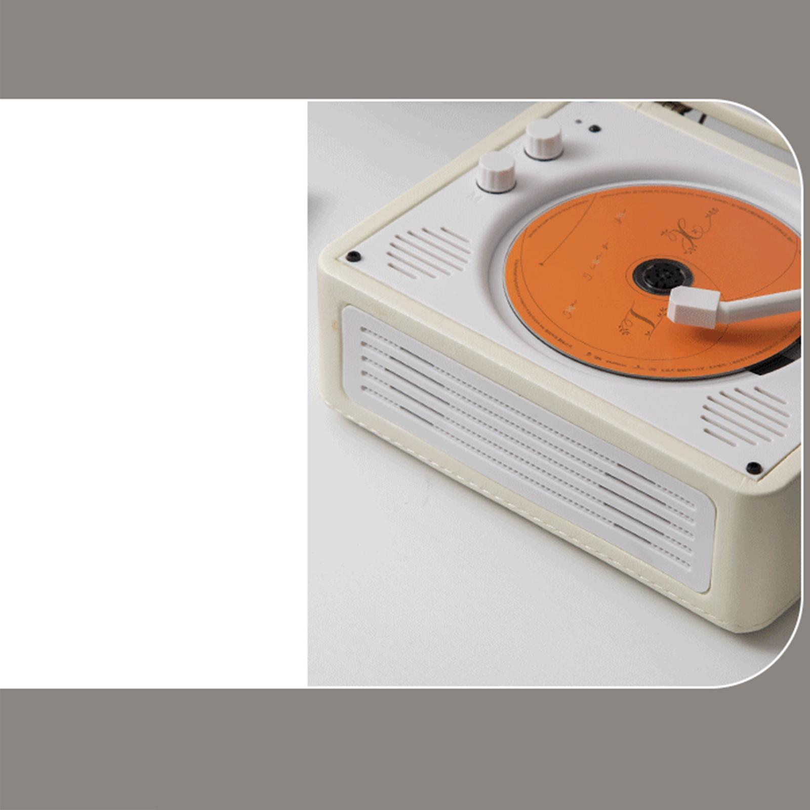 Beige Plattenspieler mit orangefarbener CD. Zwei weiße Knöpfe sind sichtbar.