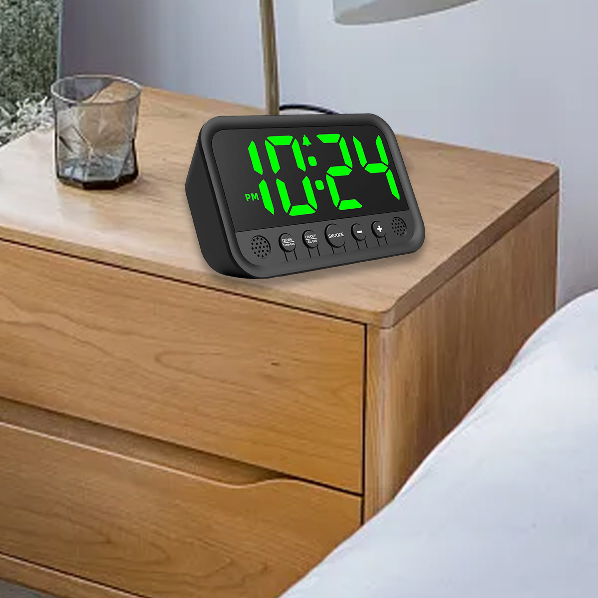 Schwarzer Digitalwecker zeigt 10:24 Uhr auf einem hölzernen Nachttisch.