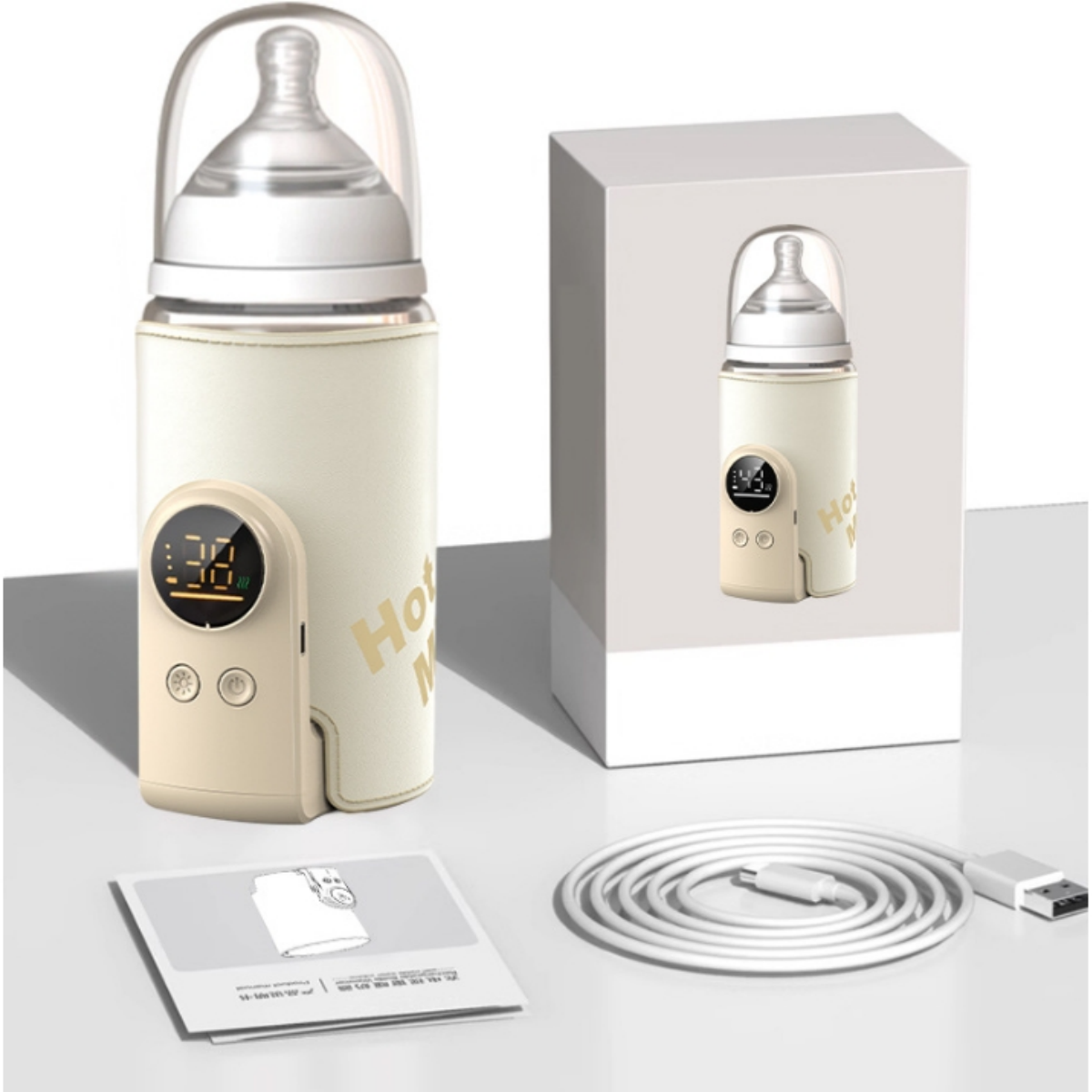 Ein Babyflaschenwärmer mit Flasche, Box und Zubehör, alles auf weißer Oberfläche.