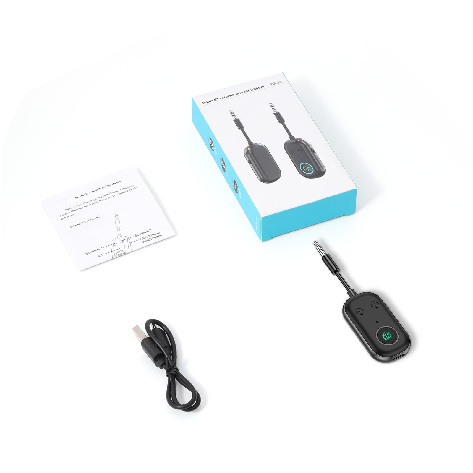 Bluetooth-Empfänger und -Sender mit Kabel, Handbuch und Verpackung auf weißer Oberfläche.