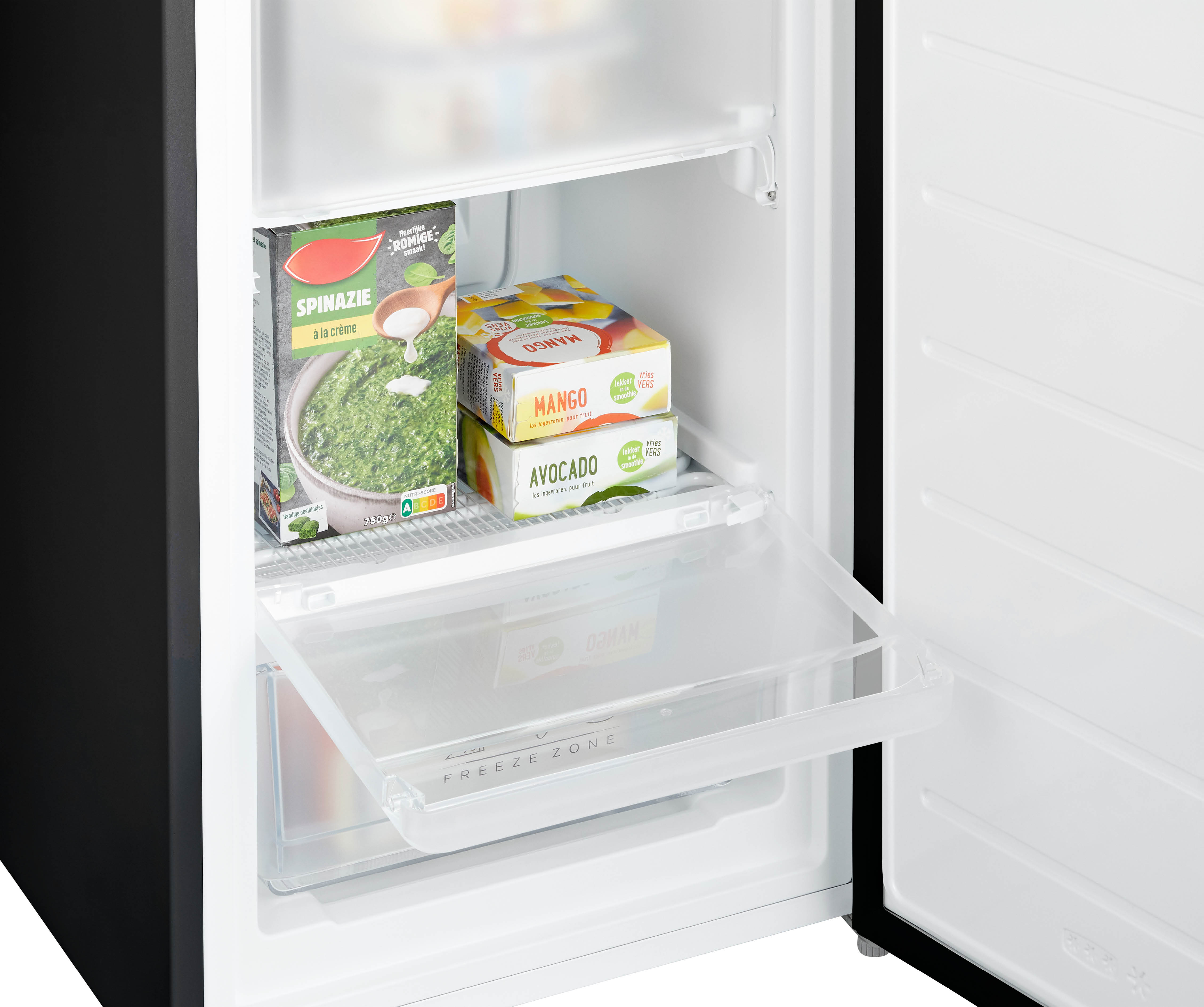 Refrigerator interior with frozen food boxes in drawers, open. Spinach, mango, and avocado.