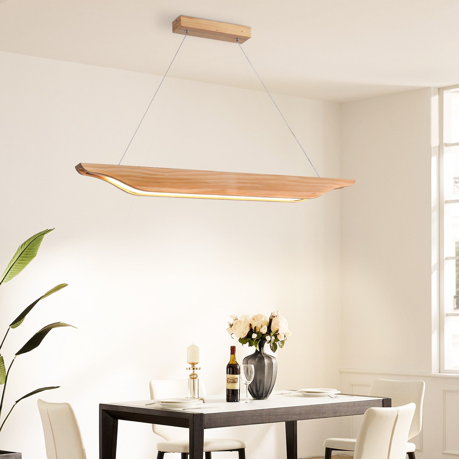 Sala da pranzo con tavolo, sedie e lampada da soffitto in legno sopra il tavolo.