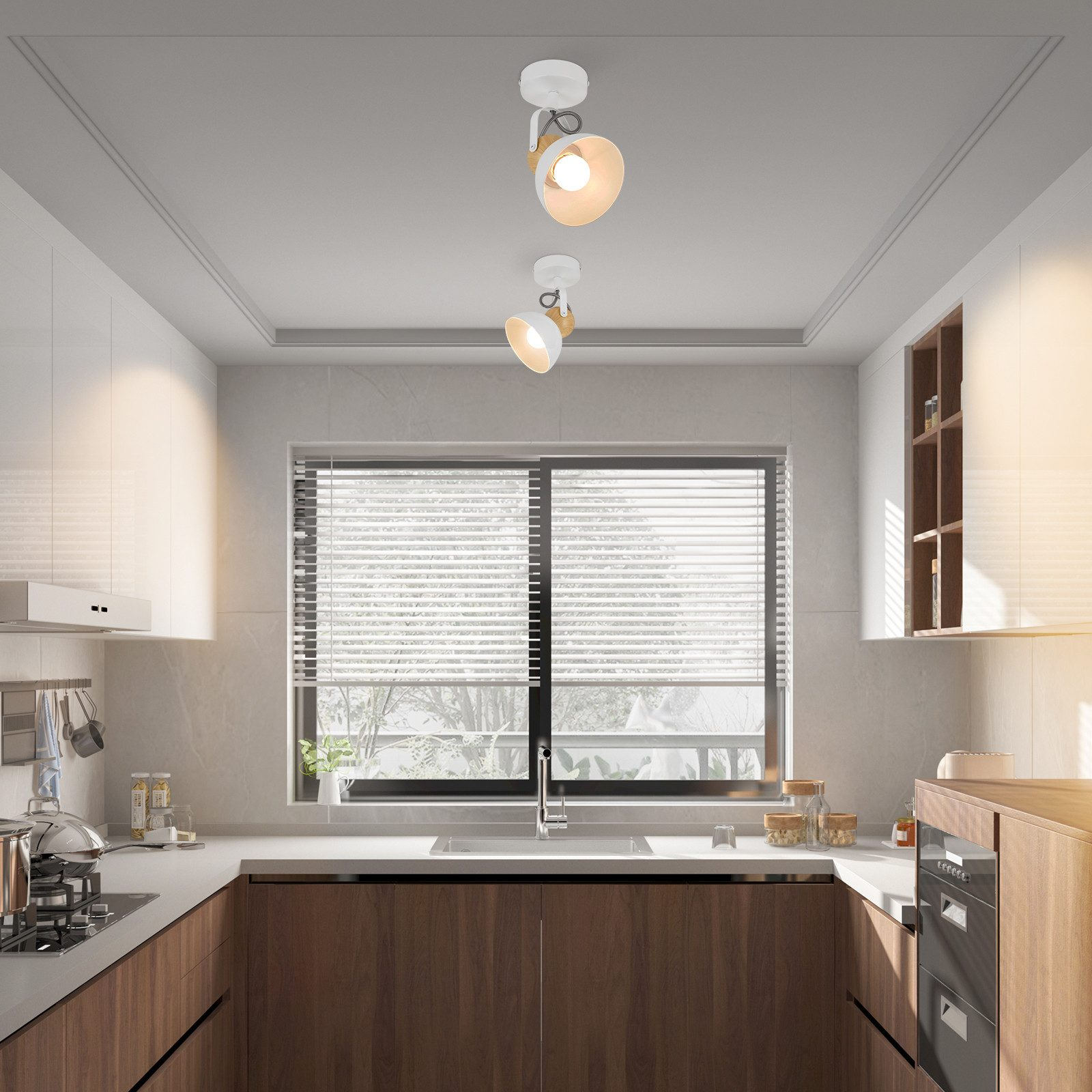 Nowoczesna kuchnia z białymi szafkami, drewnianymi akcentami i reflektorami sufitowymi.