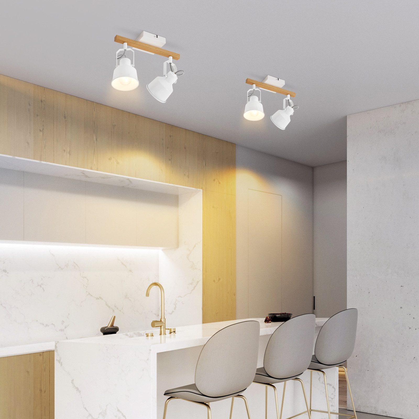 Białe, drewniane reflektory szynowe zamontowane na suficie nad wyspą kuchenną ze stołkami.