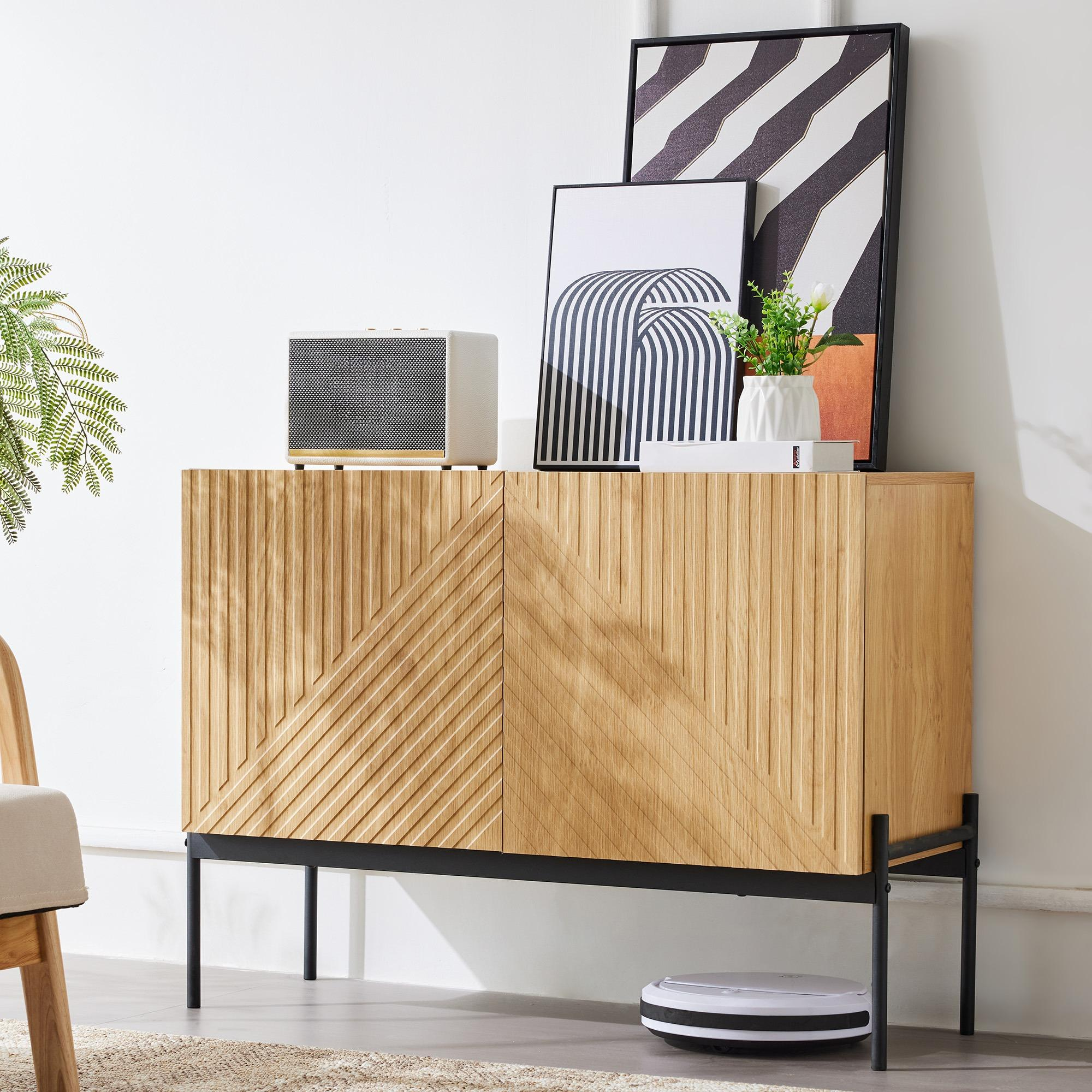 Holzschrank mit Kunst und Dekoration. Ein weißer Lautsprecher und ein Roboterstaubsauger.