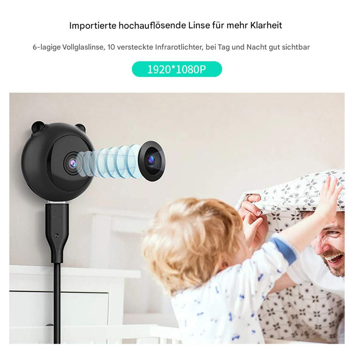 Eine kleine schwarze Kamera mit Kabel ist auf ein Kind und einen Erwachsenen gerichtet.