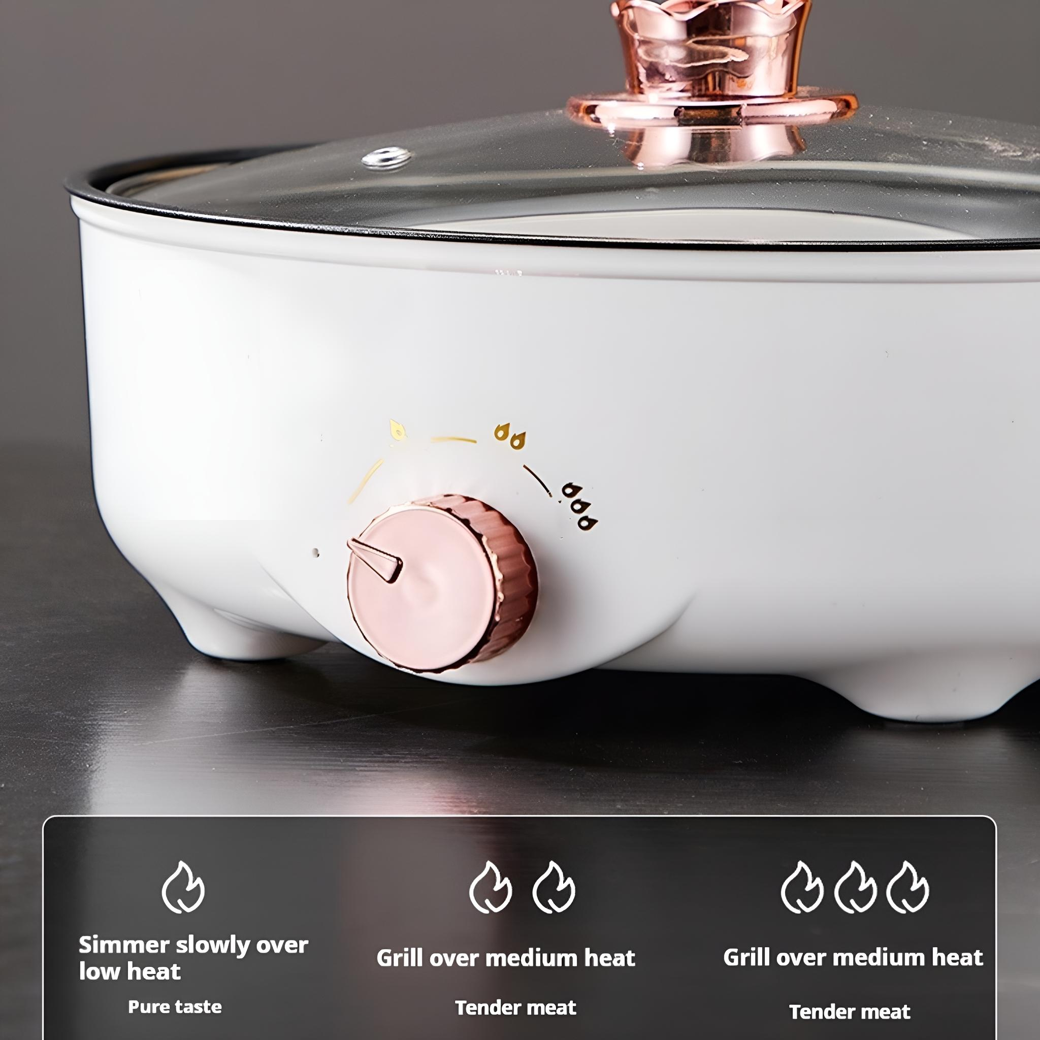 Weißer Elektroherd mit roségoldenem Knopf. Der Herd hat einen Glasdeckel und Symbole.