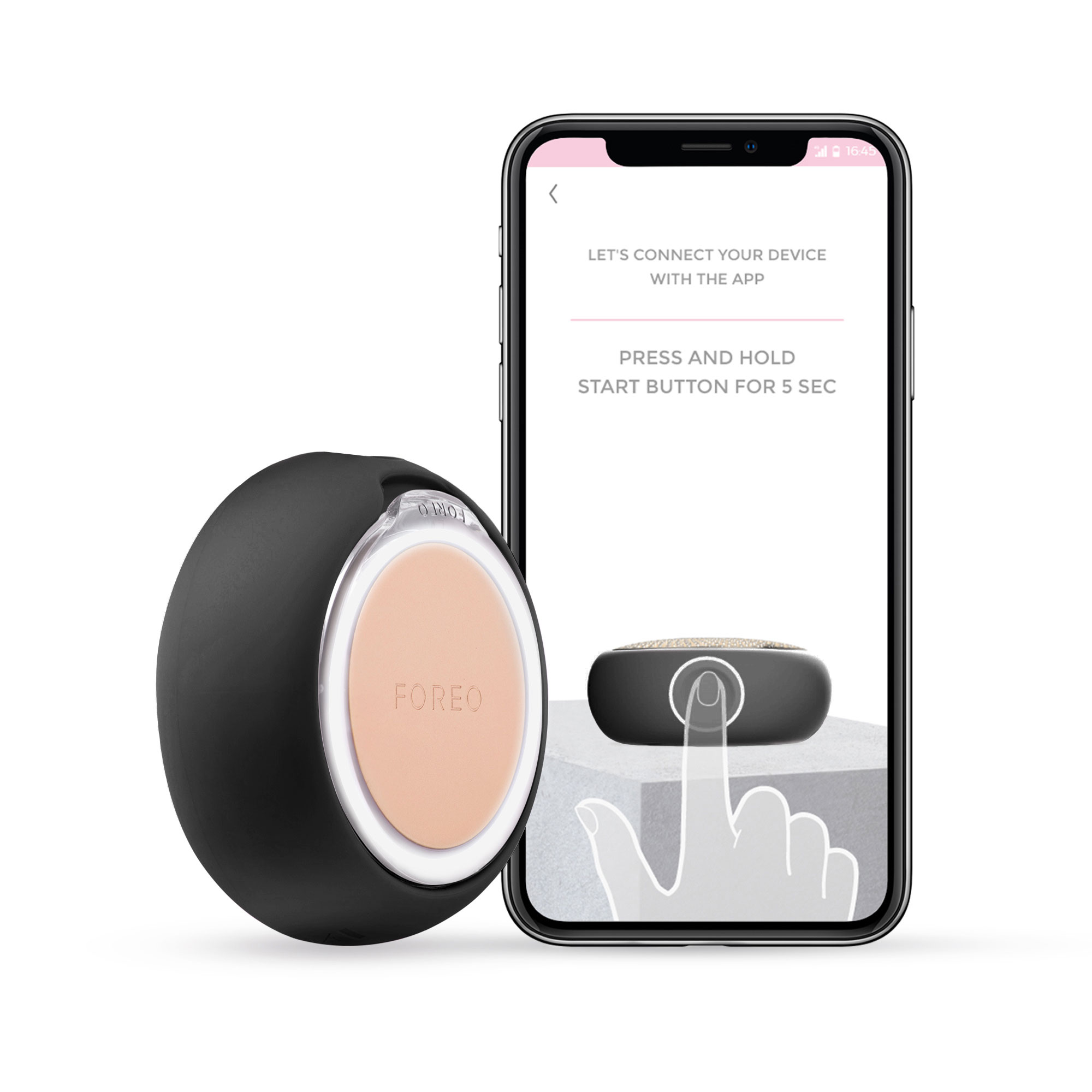Dispositivo Foreo y teléfono. Teléfono muestra instrucciones de la aplicación. Dispositivo negro.