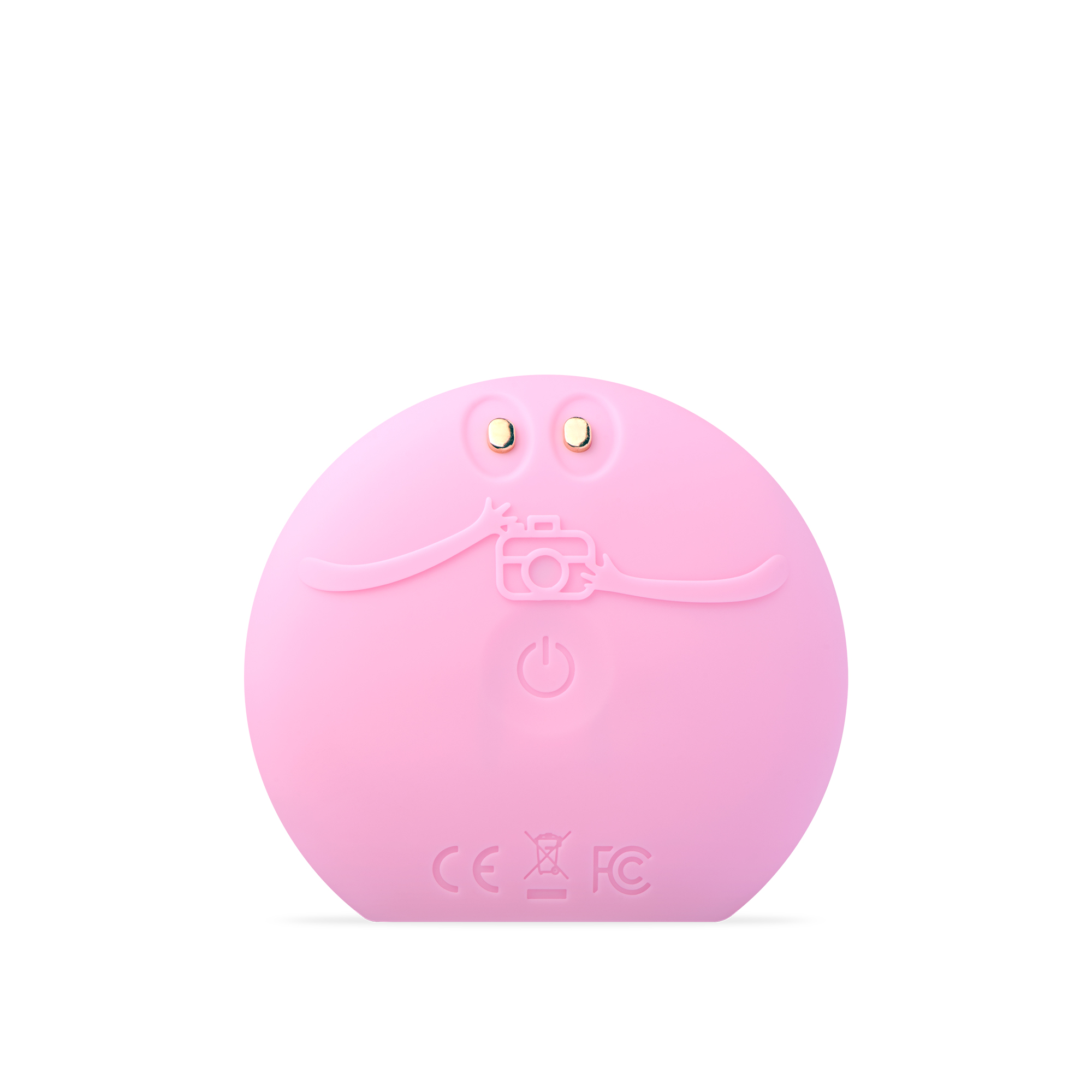 Un dispositivo rosa de limpieza facial con un icono de cámara, botón de encendido y dos puntos dorados.