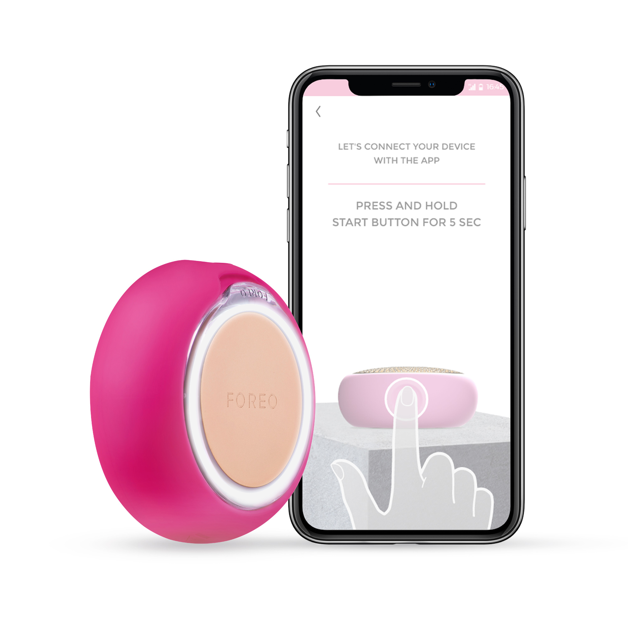Dispositivo FOREO rosa y un teléfono que muestra instrucciones. Mano señalando el dispositivo en la pantalla.