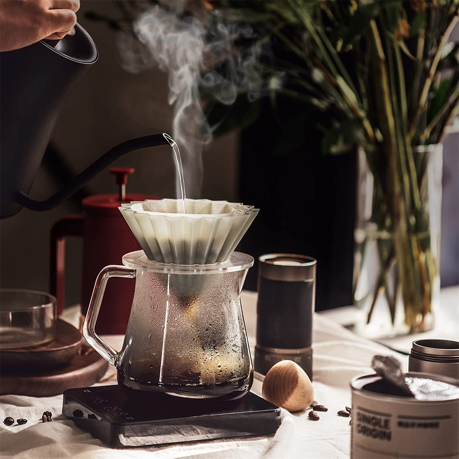 Heißes Wasser über einen Kaffeefilter auf einer Glaskaraffe gießen. Kaffeemaschinen-Szene.