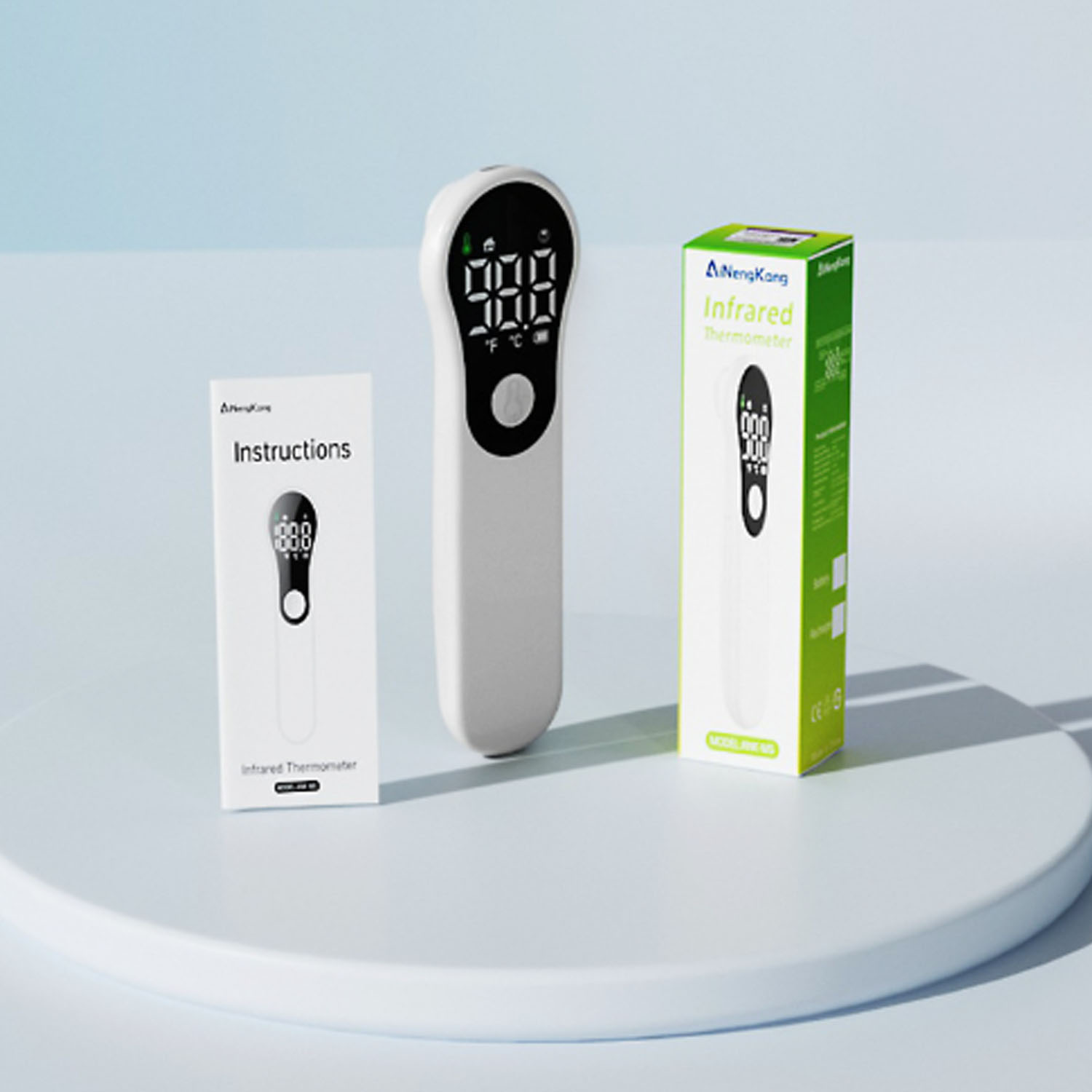 Infrarot-Thermometer, Anleitung und Schachtel auf weißem Untergrund; alles weiß und grün.