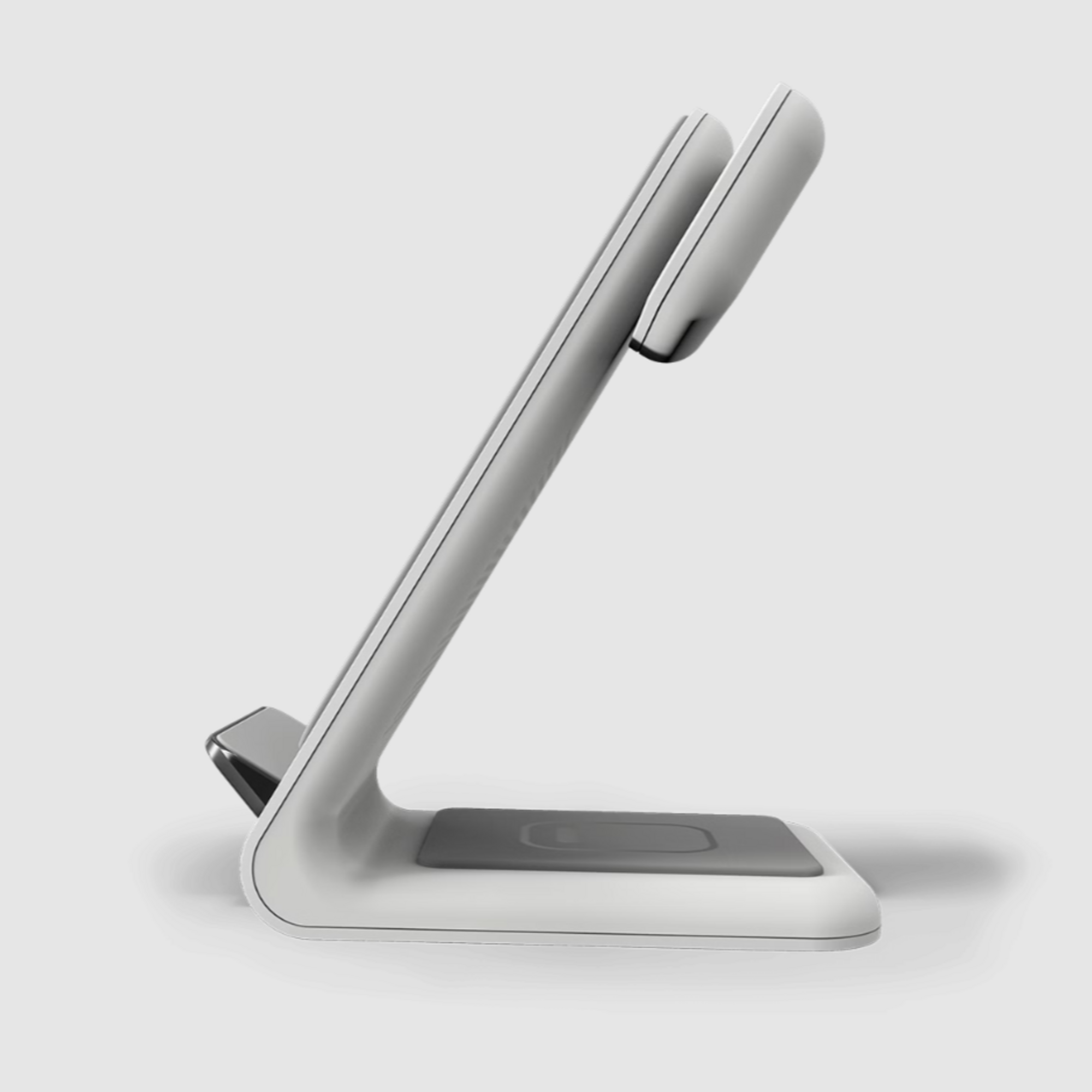 Un supporto di ricarica bianco con slot per telefono e orologio.