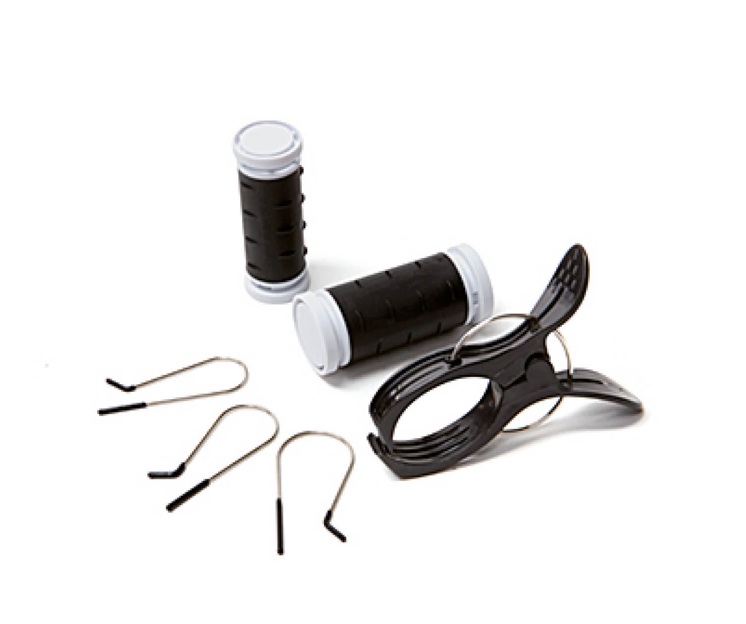 Hair rollers, hair clips, and a black clip on a white surface.