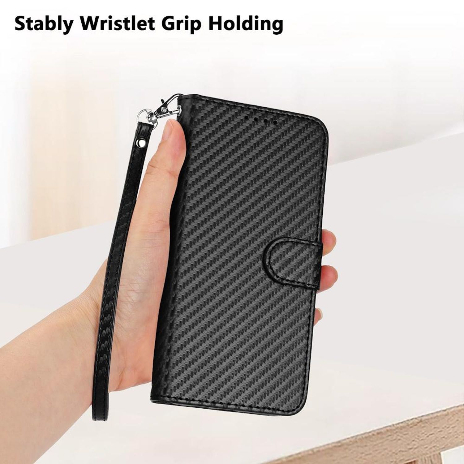 Eine Hand hält eine schwarze Handyhülle mit einer Handschlaufe. Text: Stabile Handgelenk-Griffhaltung.