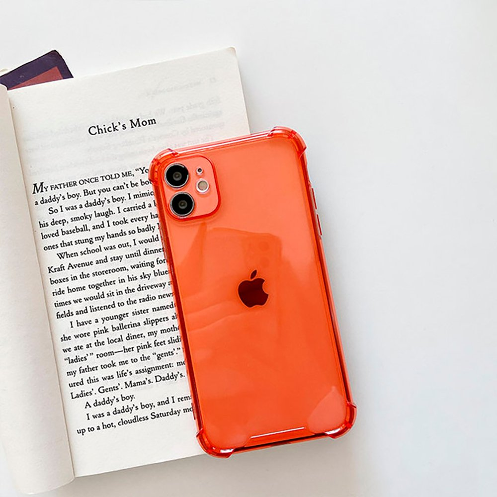 Funda de teléfono naranja sobre un libro con texto. El teléfono tiene un logotipo de Apple.