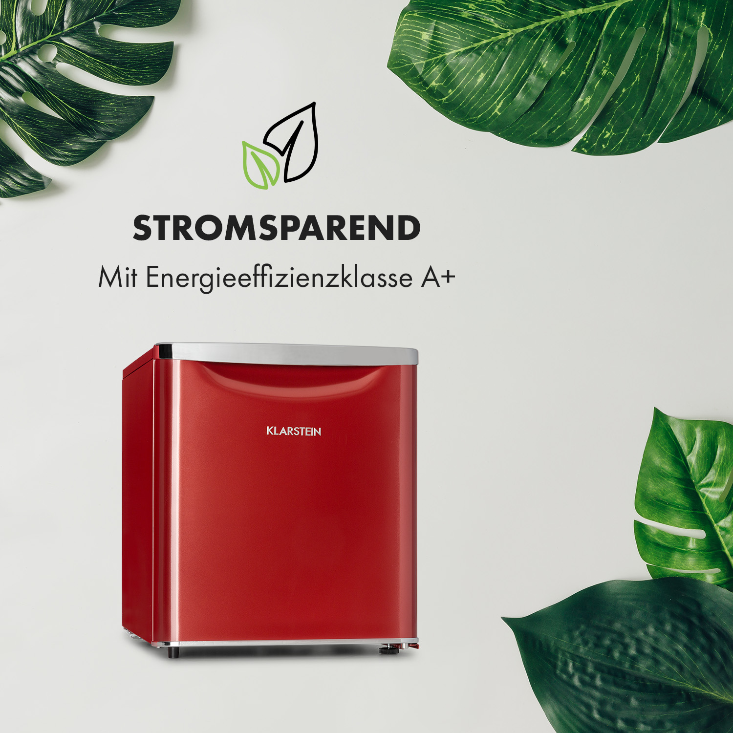Mini frigo rosso con testo e foglie su sfondo bianco. Efficienza energetica.