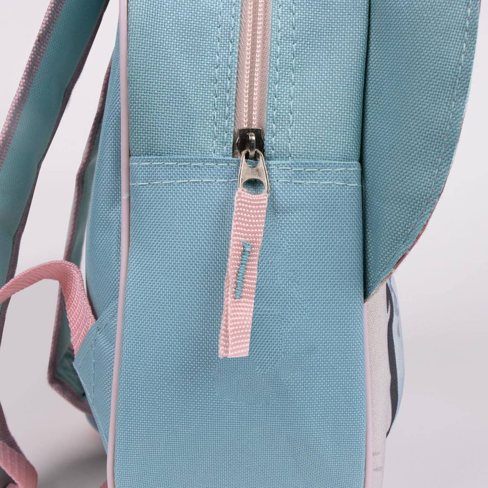 Detalle de mochila azul con cremallera rosa y tirador rosa.
