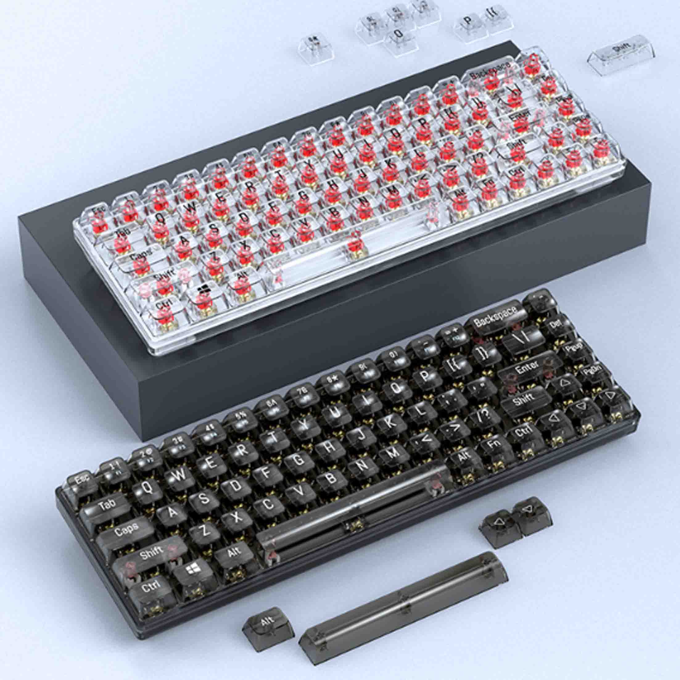 Dwie klawiatury, jedna z czerwonymi klawiszami, druga z czarnymi, na ciemnej platformie.