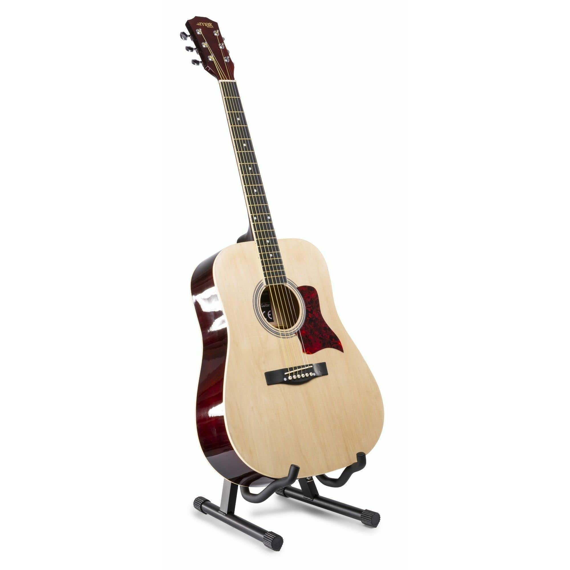 Una guitarra acústica en un soporte. La guitarra es marrón con un golpeador rojo.