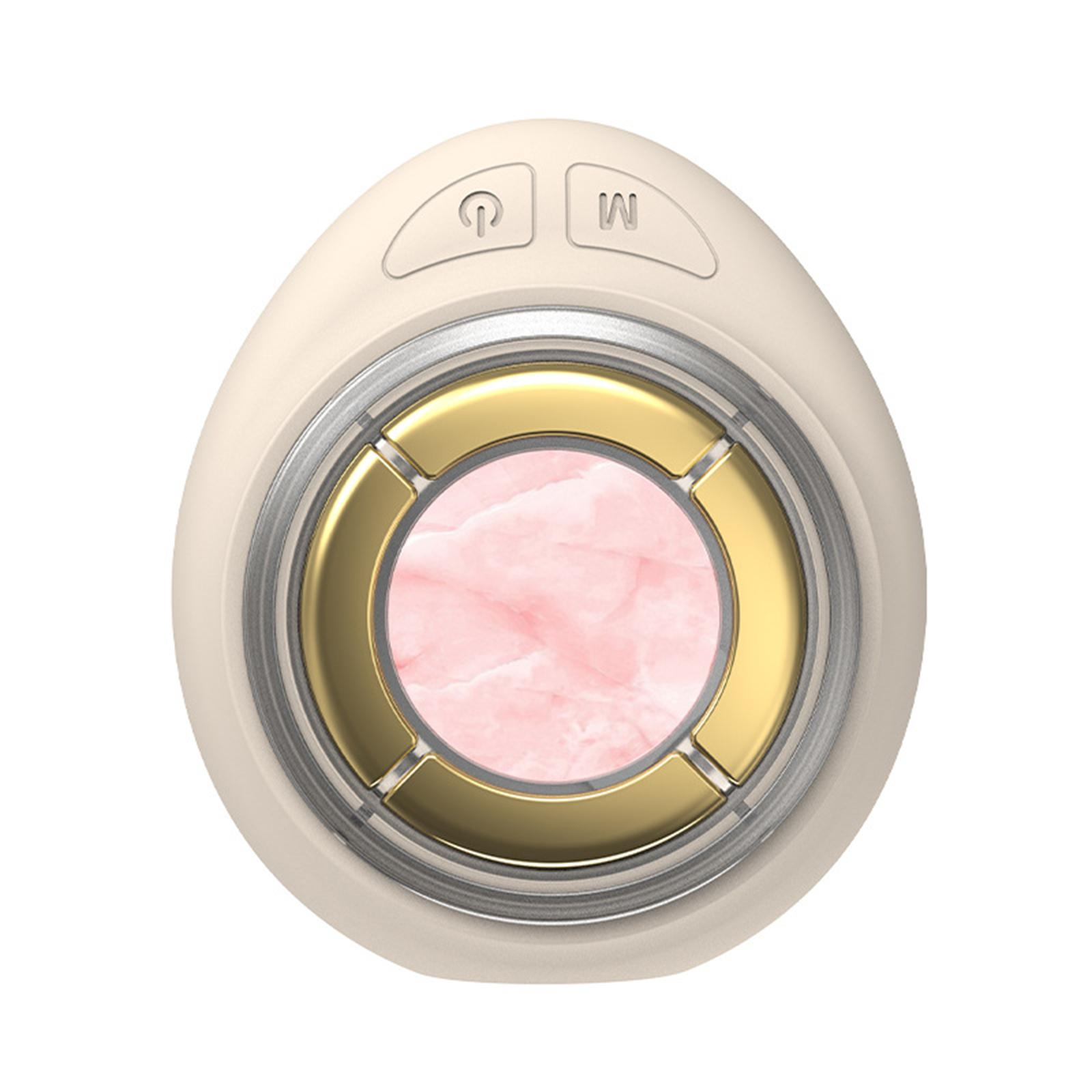 Draufsicht auf ein cremefarbenes Gerät mit Power- und Modustasten. Es hat eine rosa Mitte.