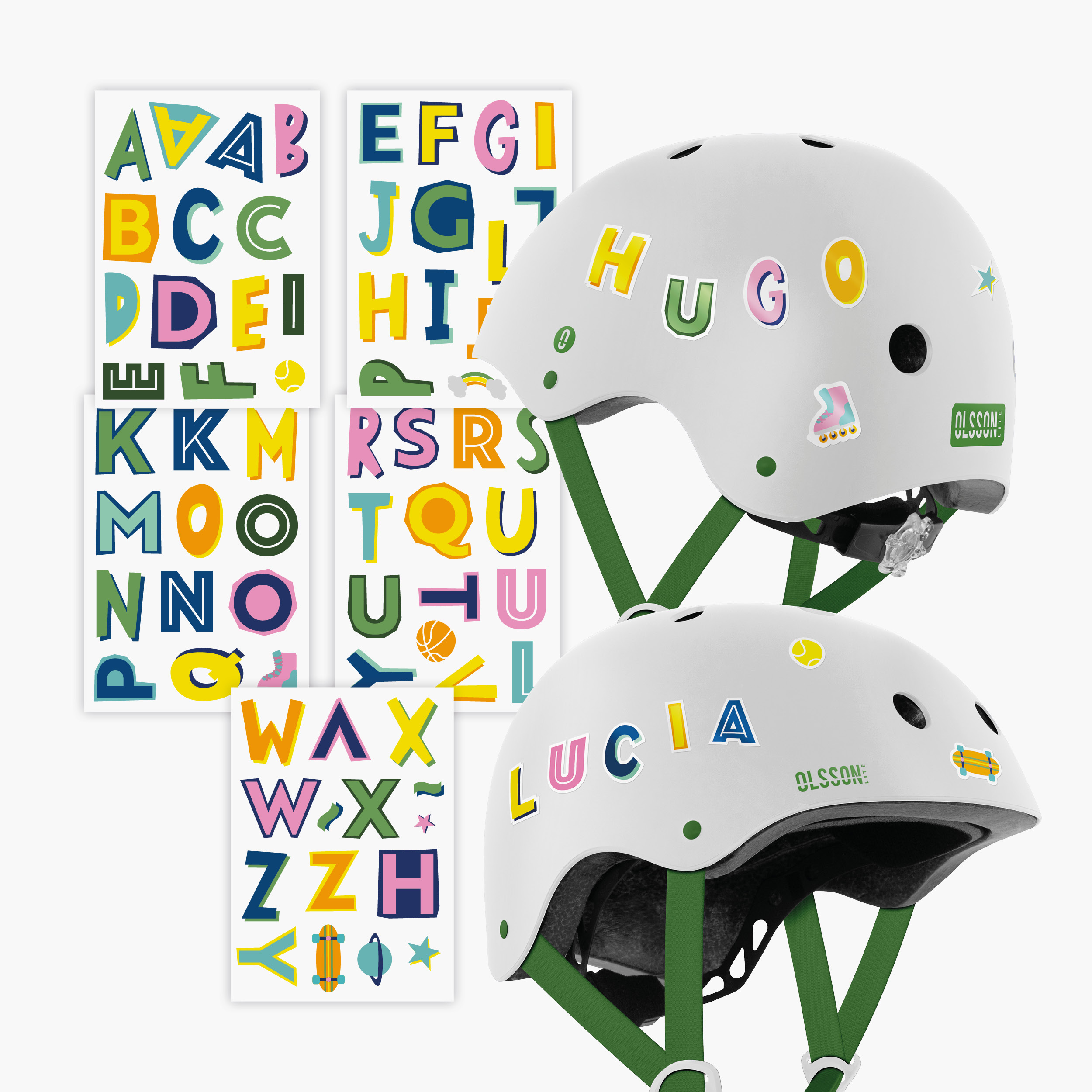 Cascos blancos con pegatinas de letras coloridas que deletrean los nombres 'Lucía' y 'Hugo'.