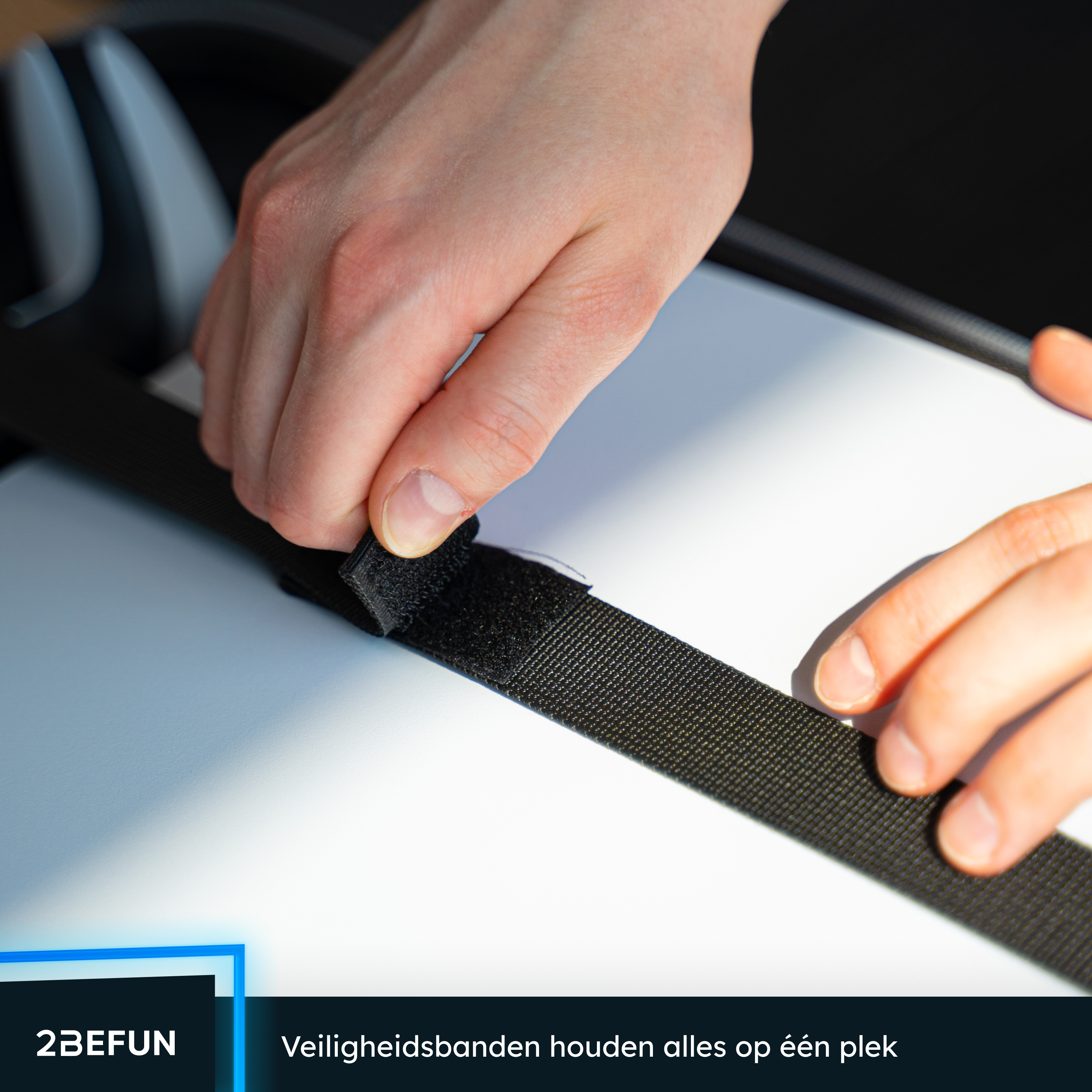 Close-up of hands attaching a black velcro strap to a white surface, safety straps keep everything in place.