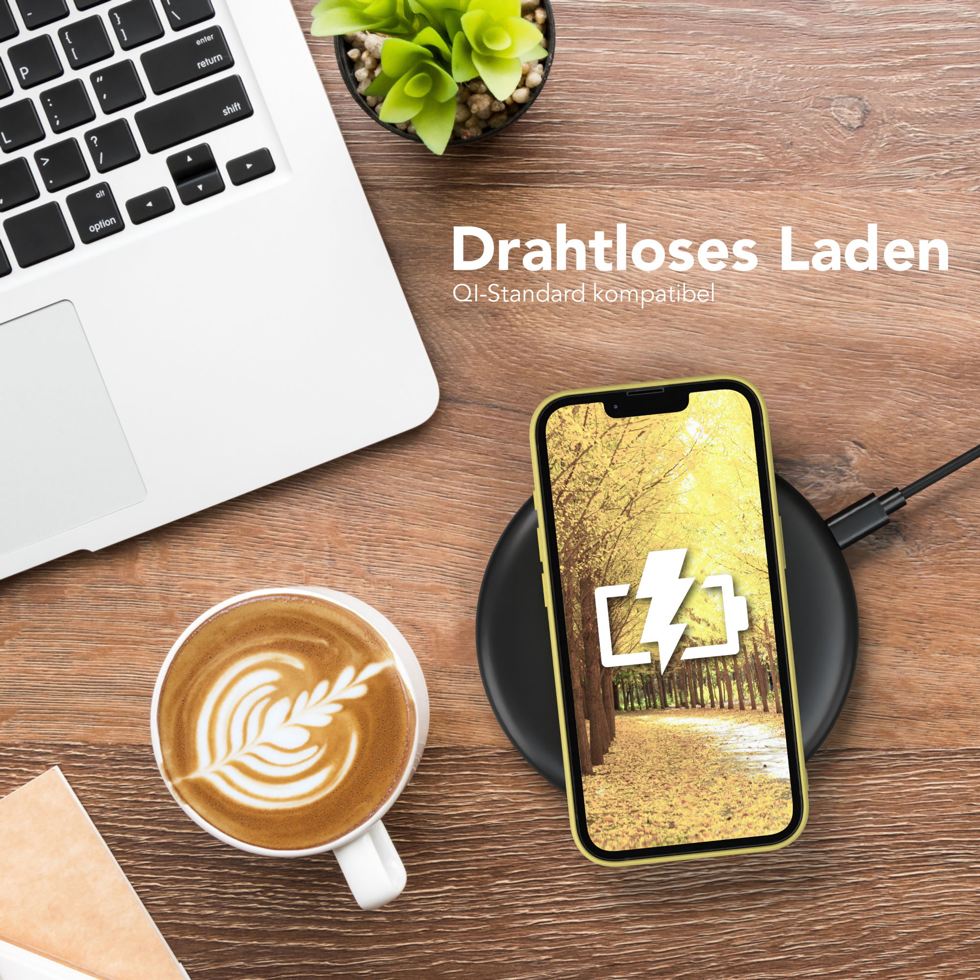 Laptop, Kaffee und Telefon auf einem Holztisch; Telefon wird geladen.