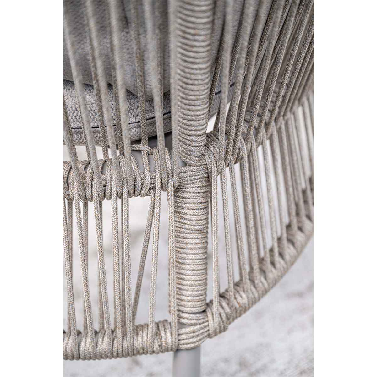 Close-up of a gray woven rope chair frame with vertical lines and a circular base.