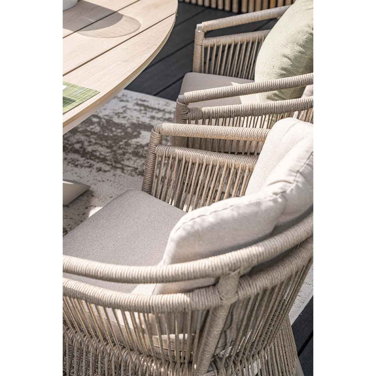 Close-up of outdoor chairs with woven rope design around the backrest and armrests.