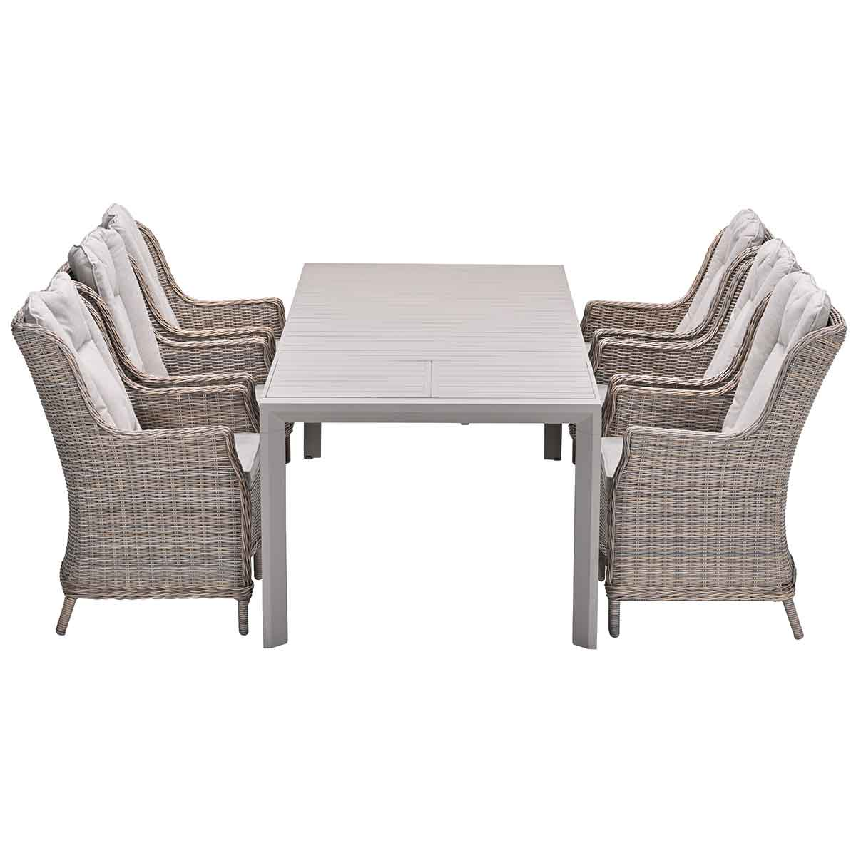 Table with six wicker chairs. Light wood table and chairs. White background.