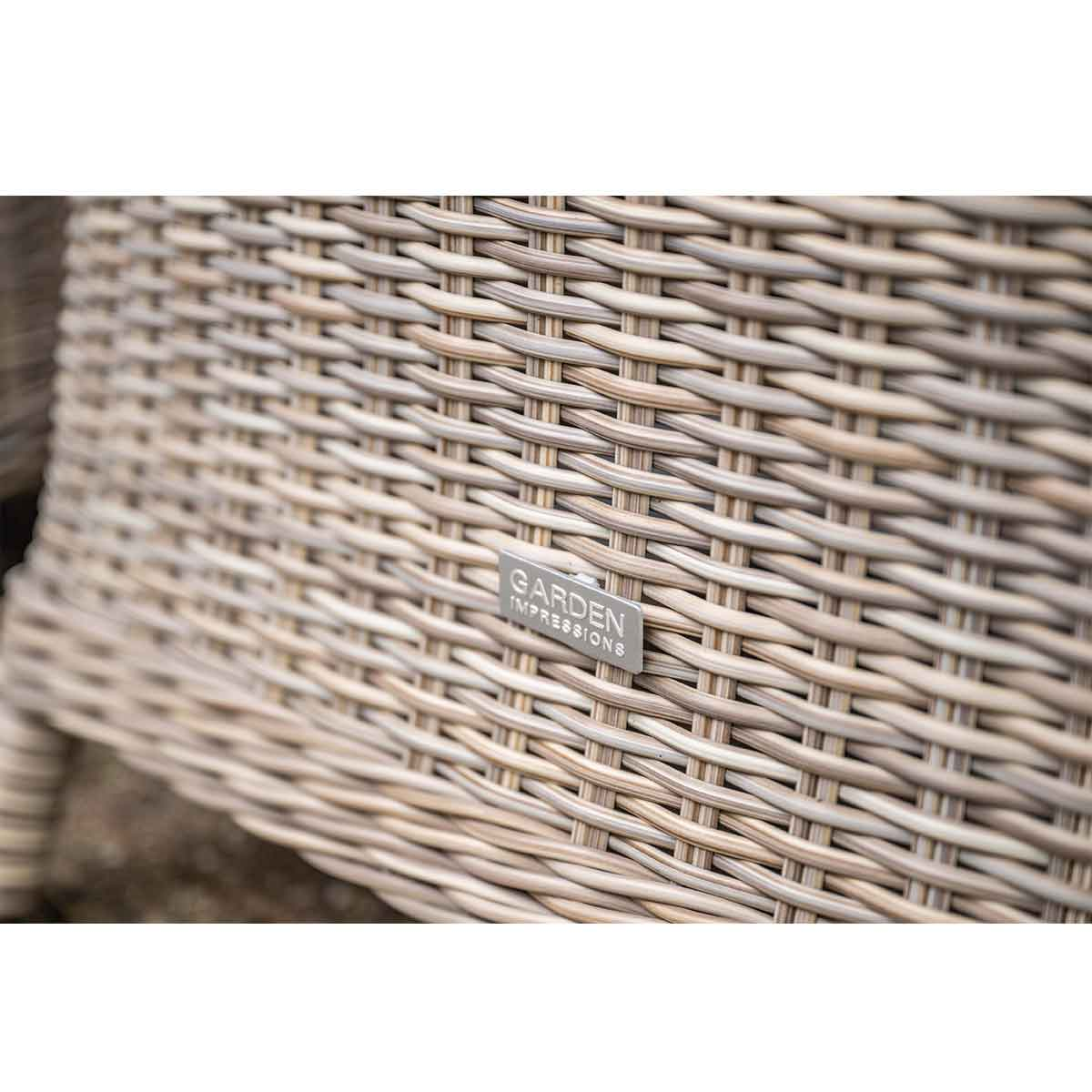 Close-up of woven chair detail with Garden Impressions logo. Beige and brown woven pattern.