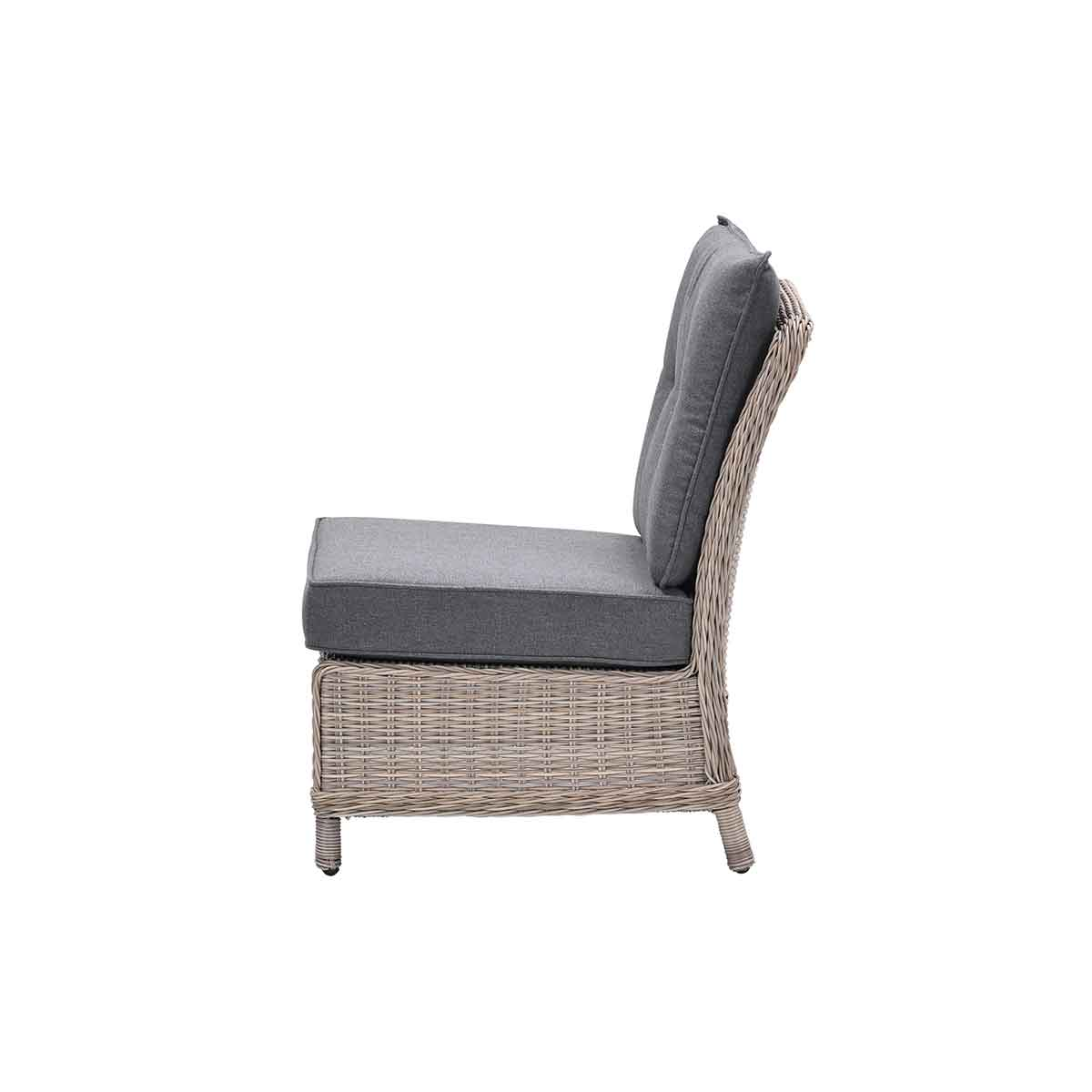 Side view of a wicker chair with a grey cushion and backrest. Isolated on white.