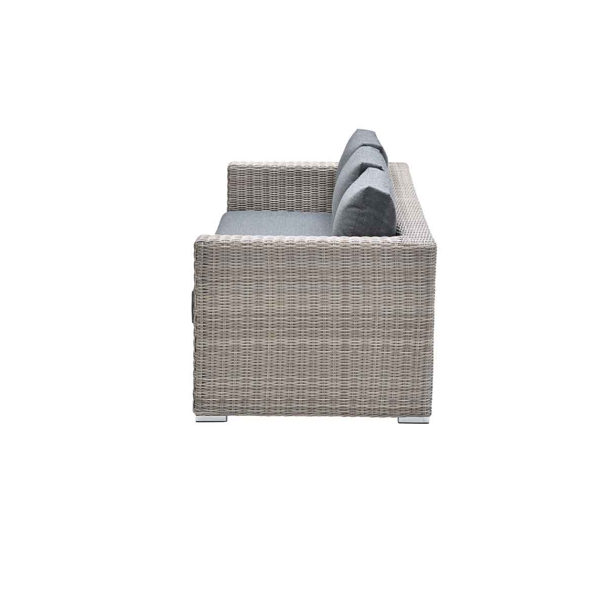 Vue latérale d'un canapé extérieur gris tissé avec coussins gris sur fond blanc.