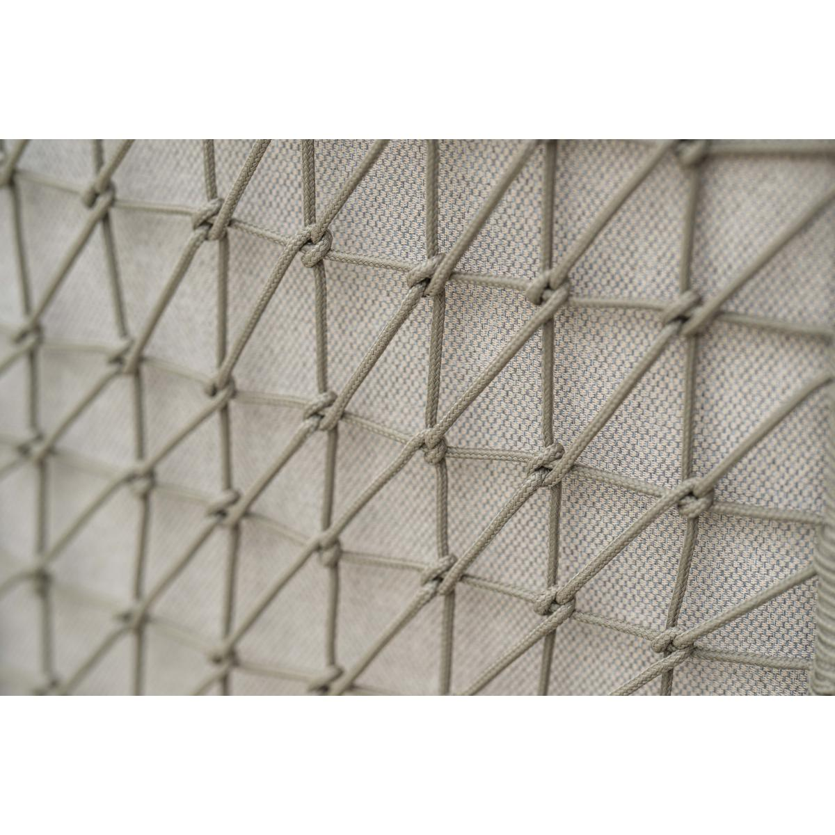 Close-up of a chair back. Grey woven rope pattern. Diagonal lines and knots. Light grey fabric backing.