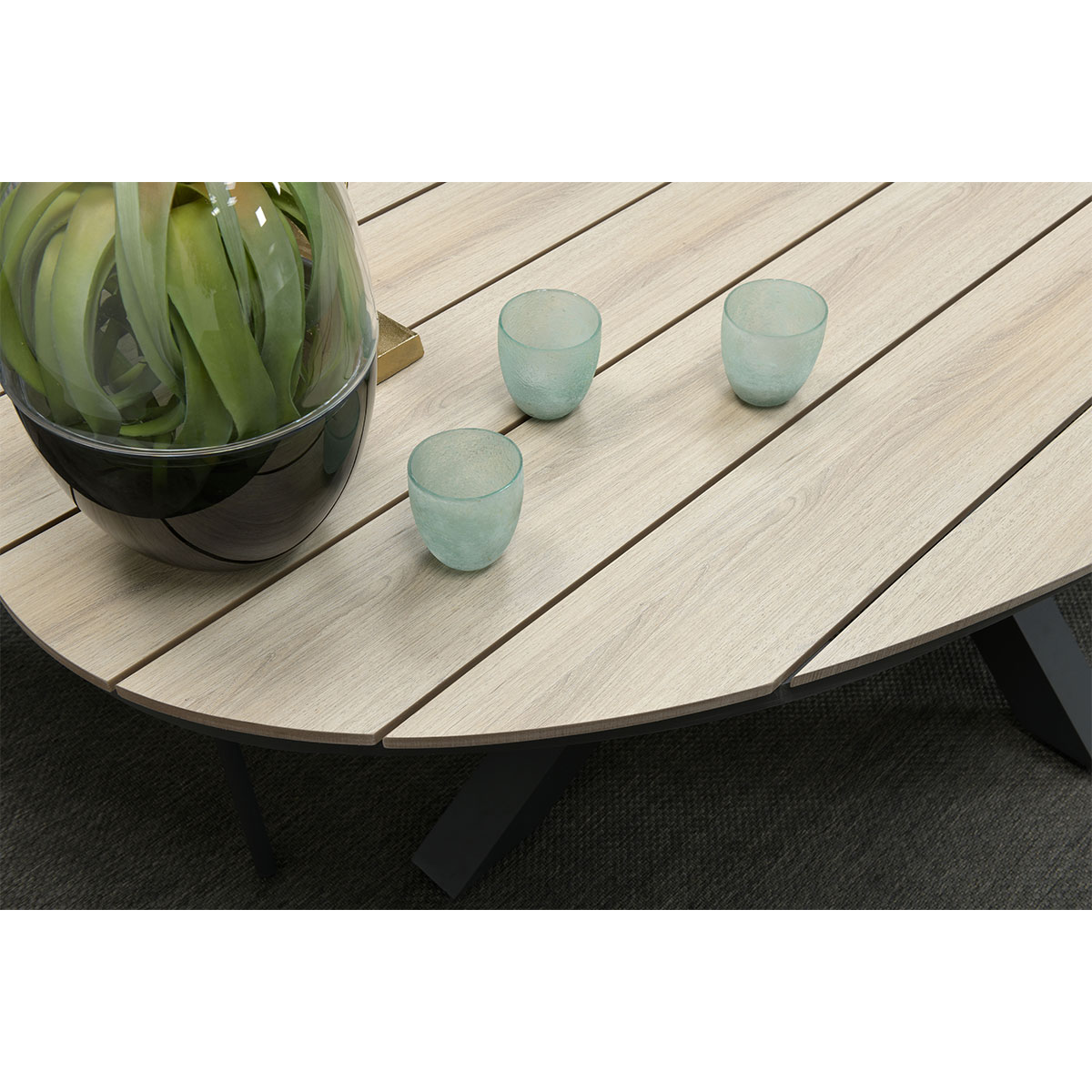 Close up of a table with green glasses and plant.