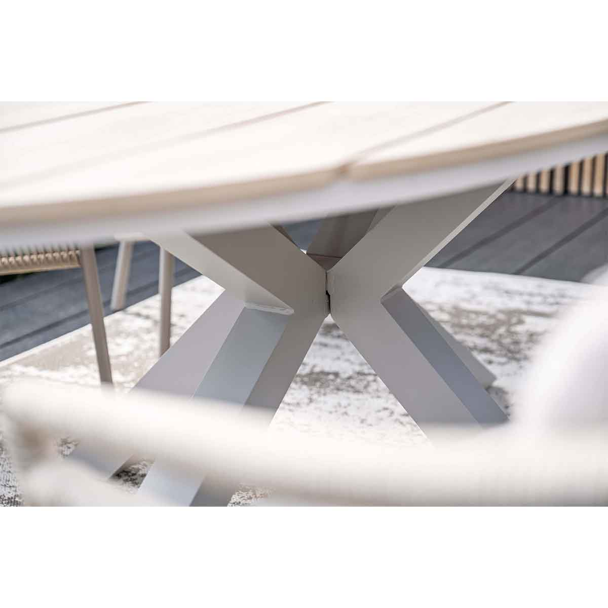Close-up view of a table base. The base appears to be made of gray metal.
