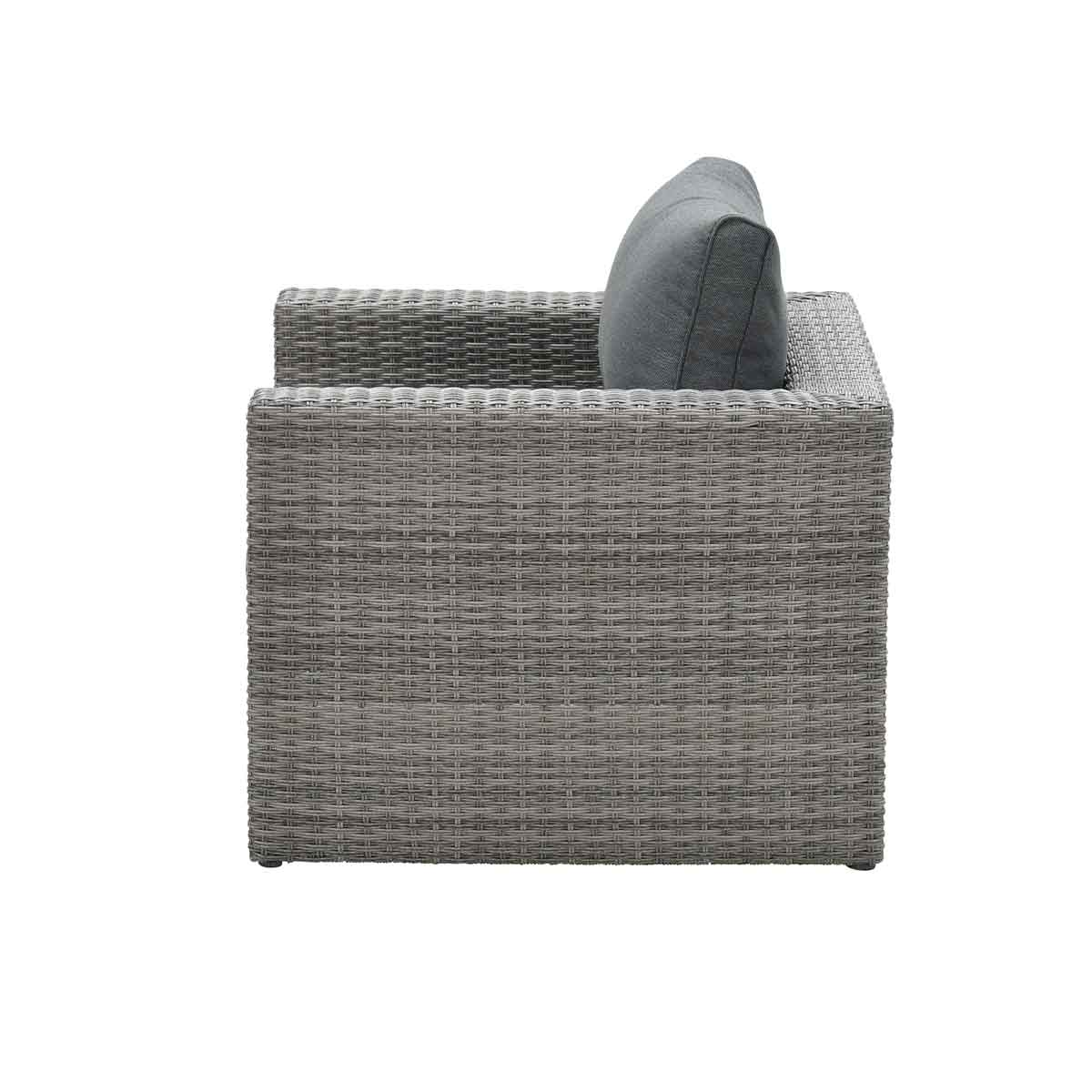 Side view of a gray wicker armchair with gray cushion and pillow. White background.