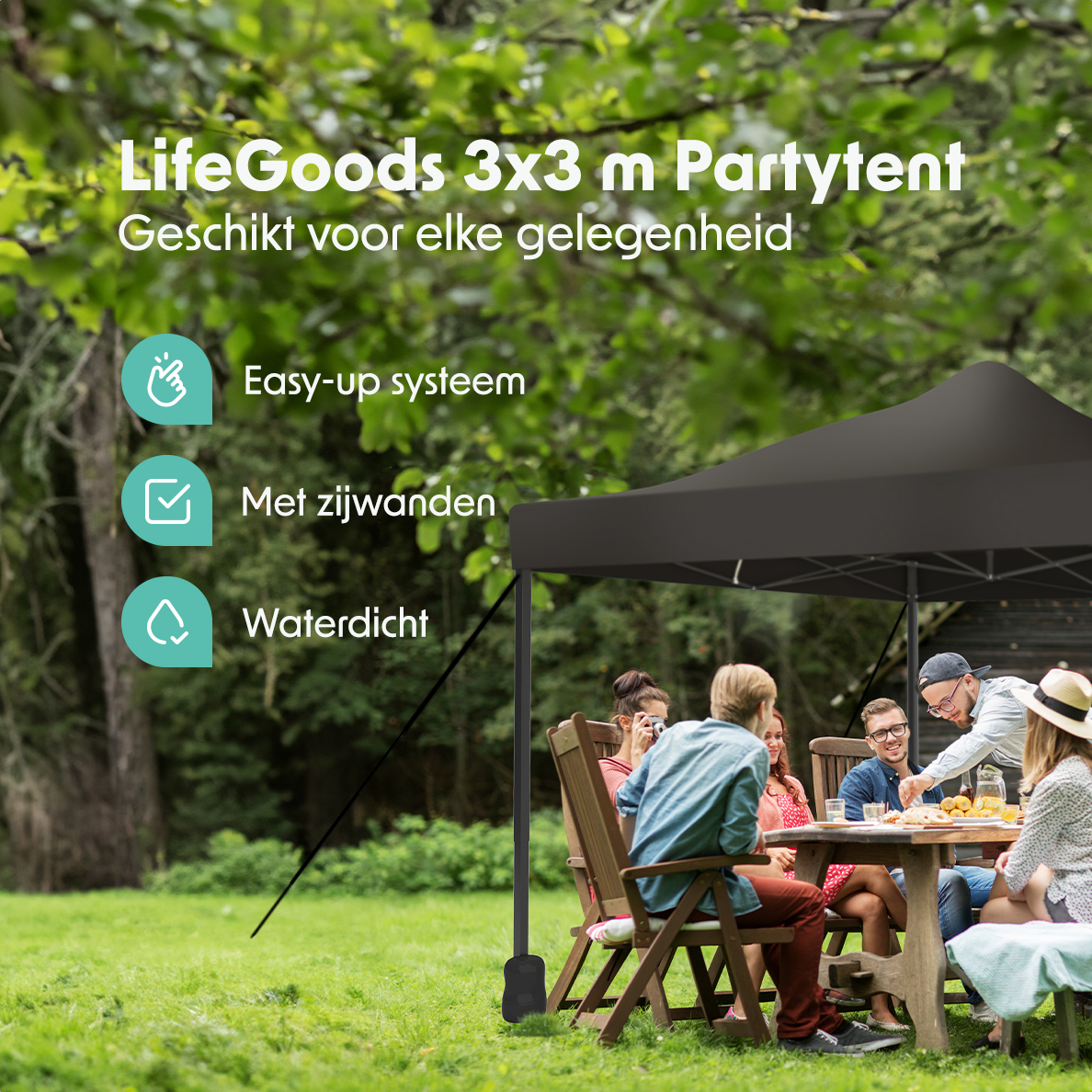 People sitting at a table under a black party tent in a garden setting with green grass.