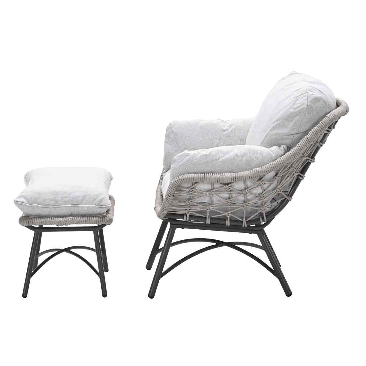 Gray armchair with an ottoman. Side view. Woven design and gray cushions.