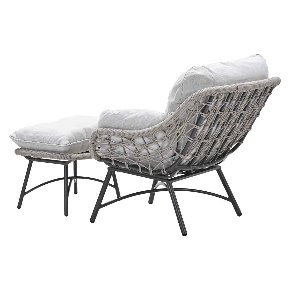Gray armchair with ottoman, rear view. Woven design and gray cushions.